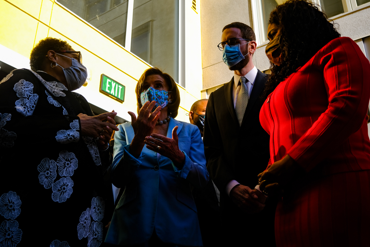 San Francisco leaders wearing masks stand together.