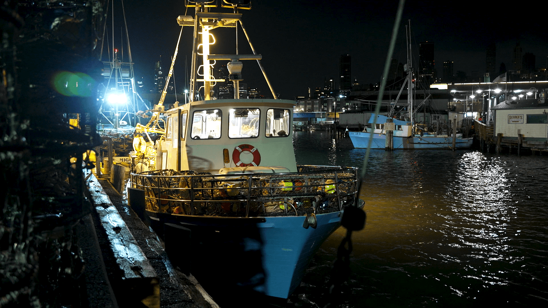 A crabbing boat sits near a harbor.