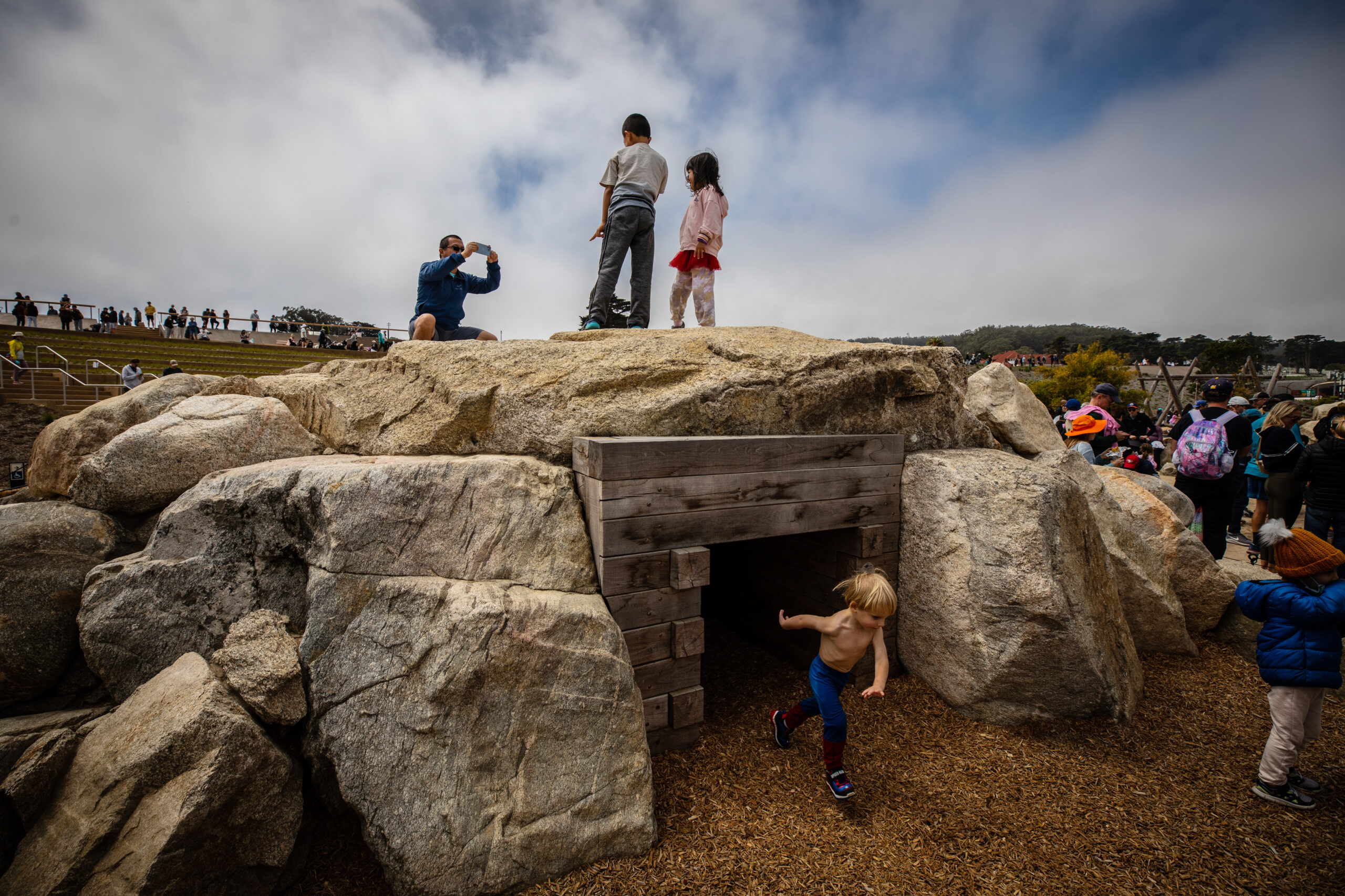 Kids playing in a rock structure.