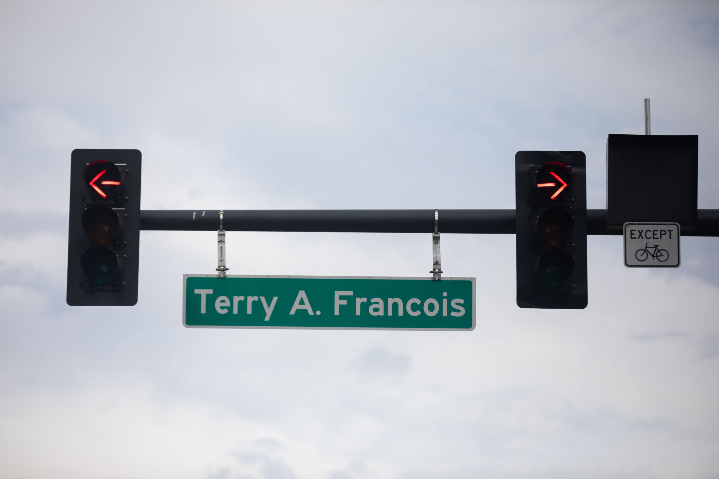 Left and right red traffics arrows surround the Terry A Francois Blvd. street sign near Chase Center in San Francisco Calif., on Wednesday, Aug. 17, 2022. The location is one of the most heavily ticketed areas for individuals parking their car, some of whom are attending events at Chase Center or Oracle Park. | Benjamin Fanjoy for The Standard