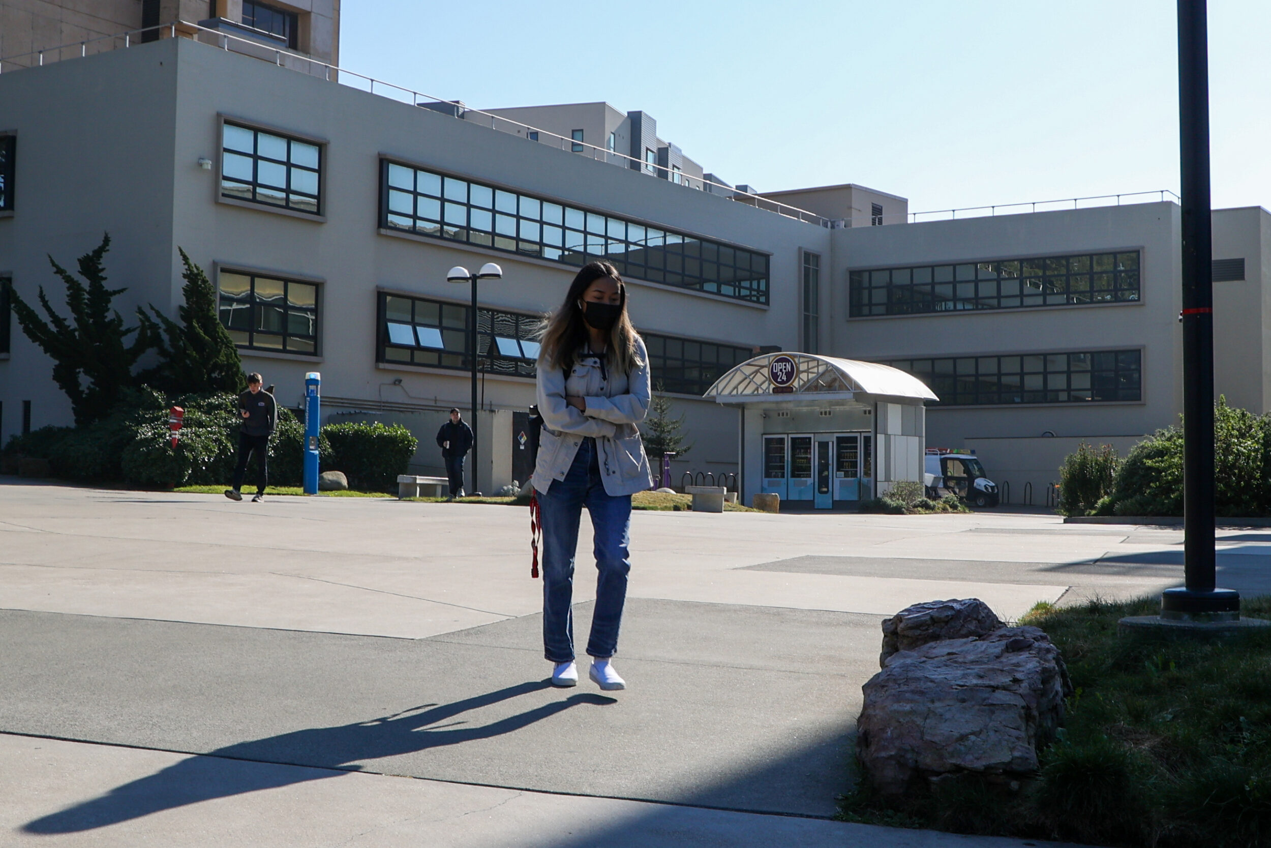 A student walks on San Francisco State University's quad.