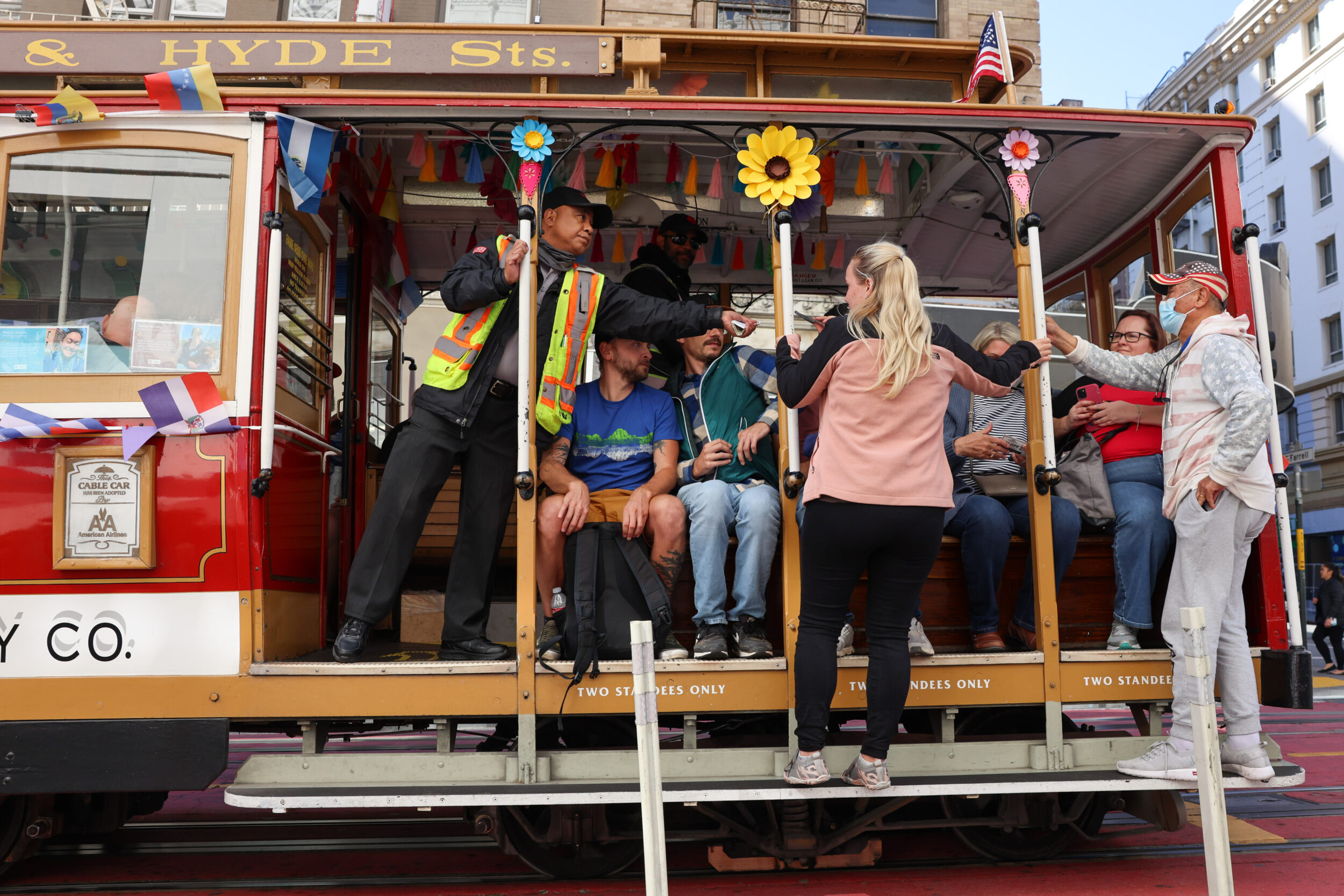 People ride a cable car. 