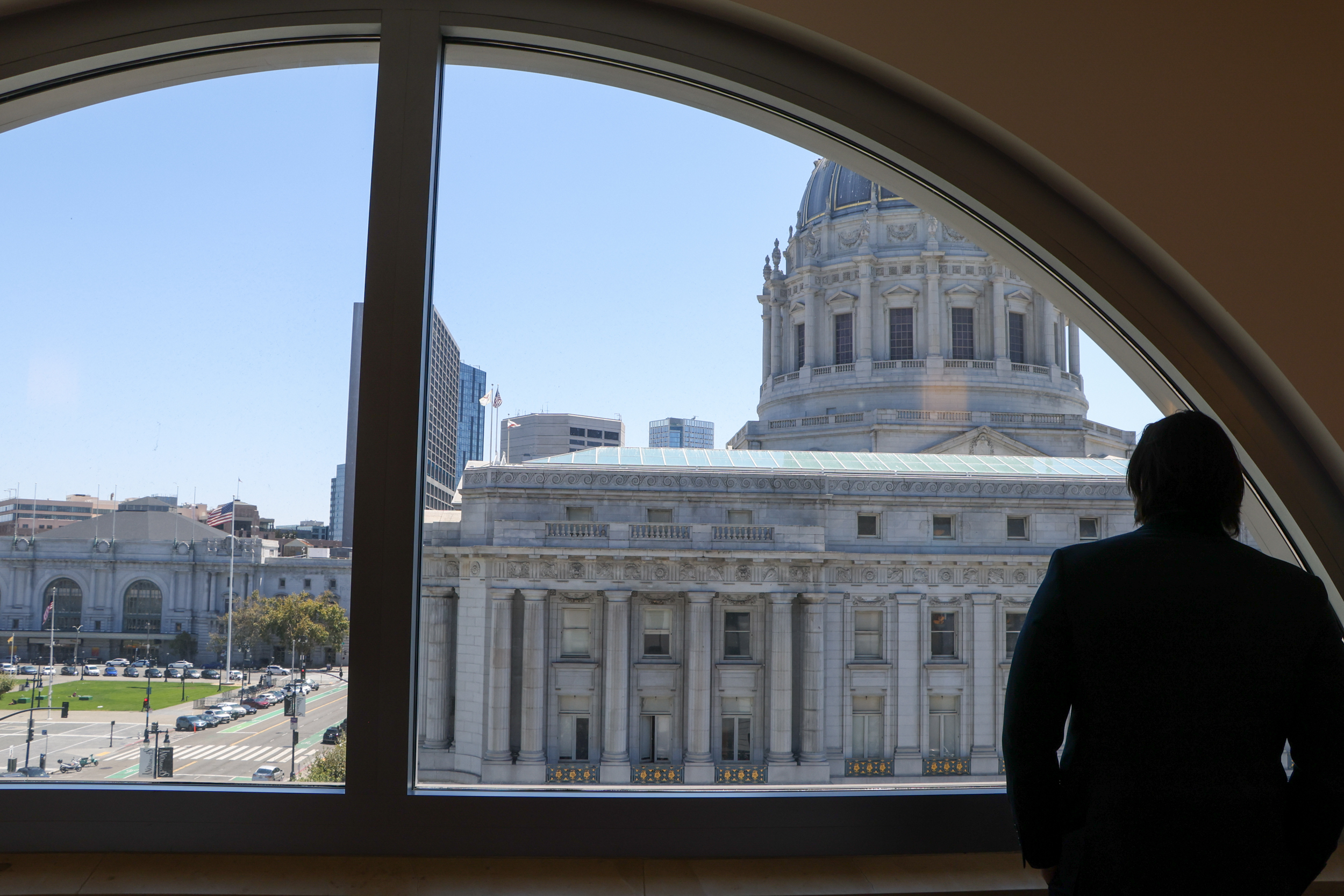San Francisco's Civic Center, including City Hall, is viewed through a semicircular courthouse window.
