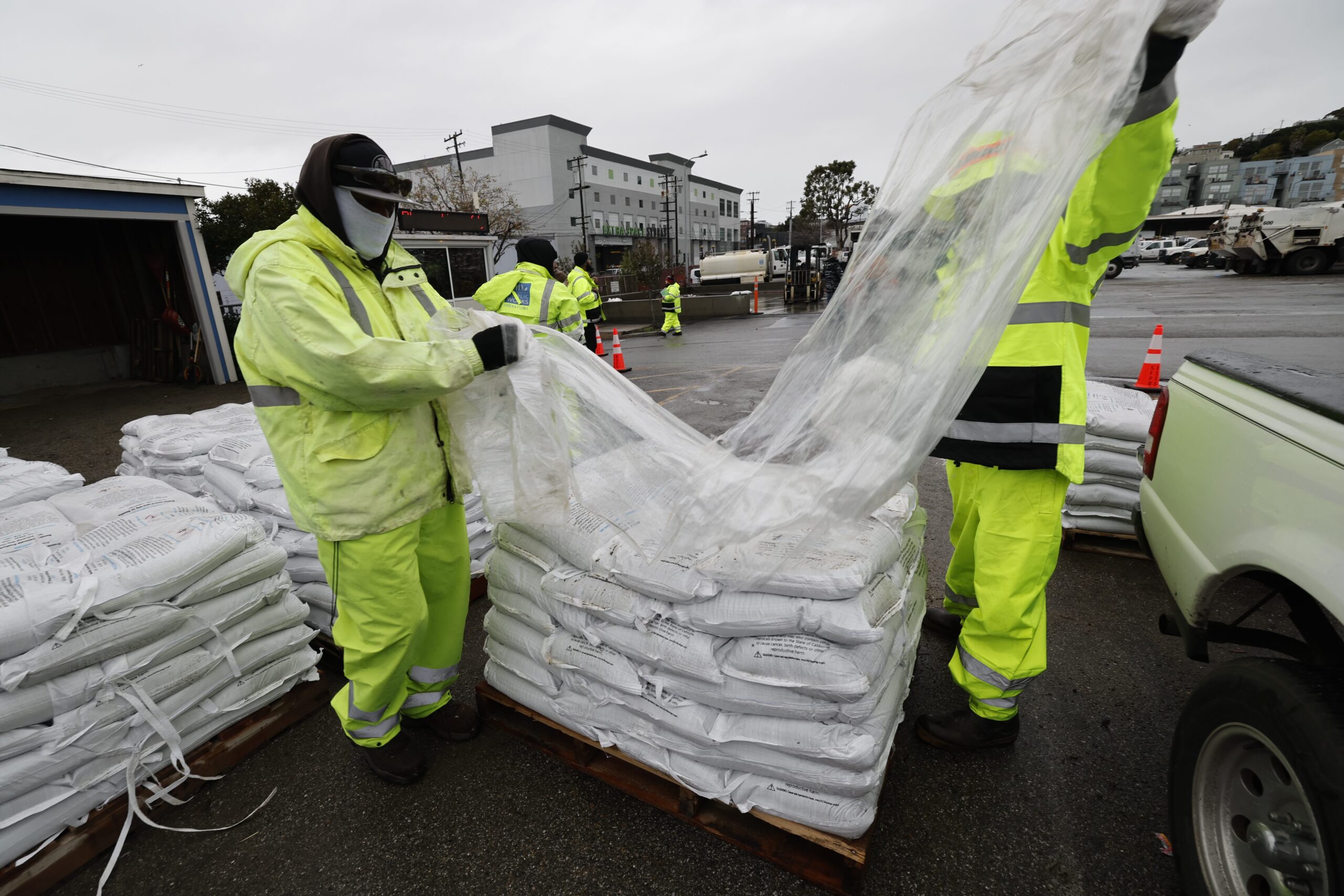 Members of the Department of Public Works unpack sandbags to distribute to the public at 2323 Cesar Chavez in San Francisco on January 4, 2023.