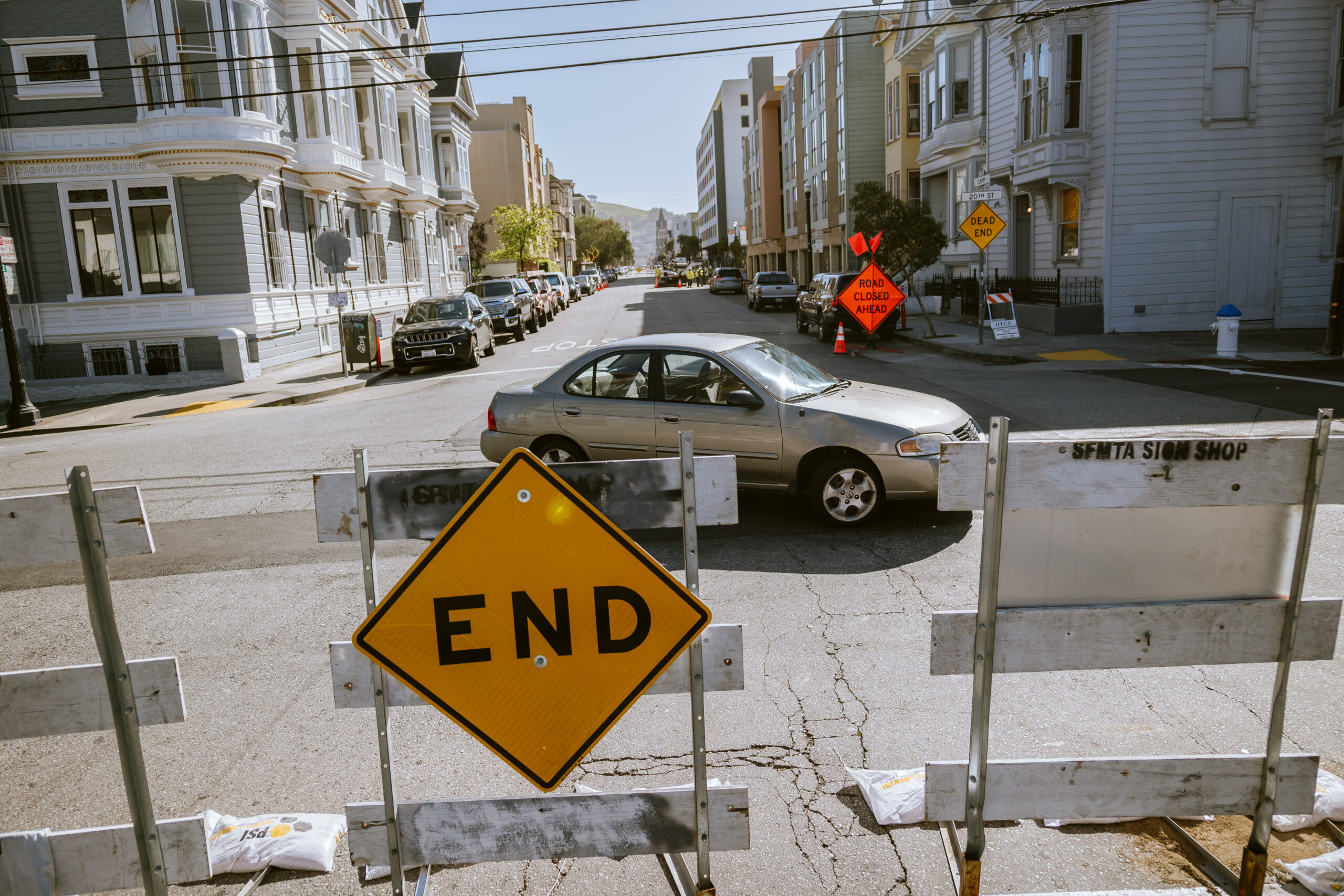 An "end" sign is attached to a barrier blocking a road in San Francisco.