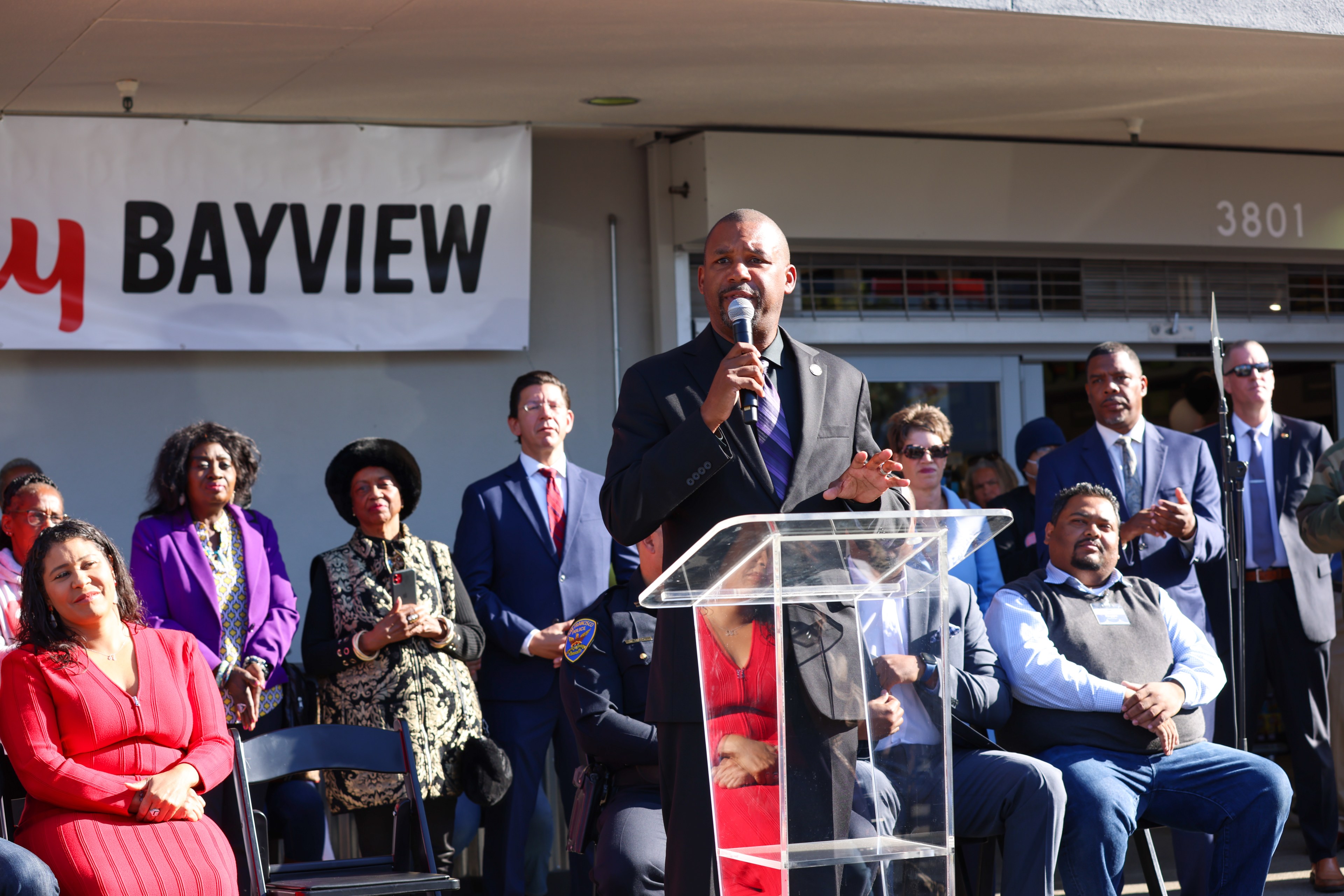 Supervisor Shamann Walton speaks at the opening of the new Lucky Bayview in front of a large crowd including Mayor London Breed.