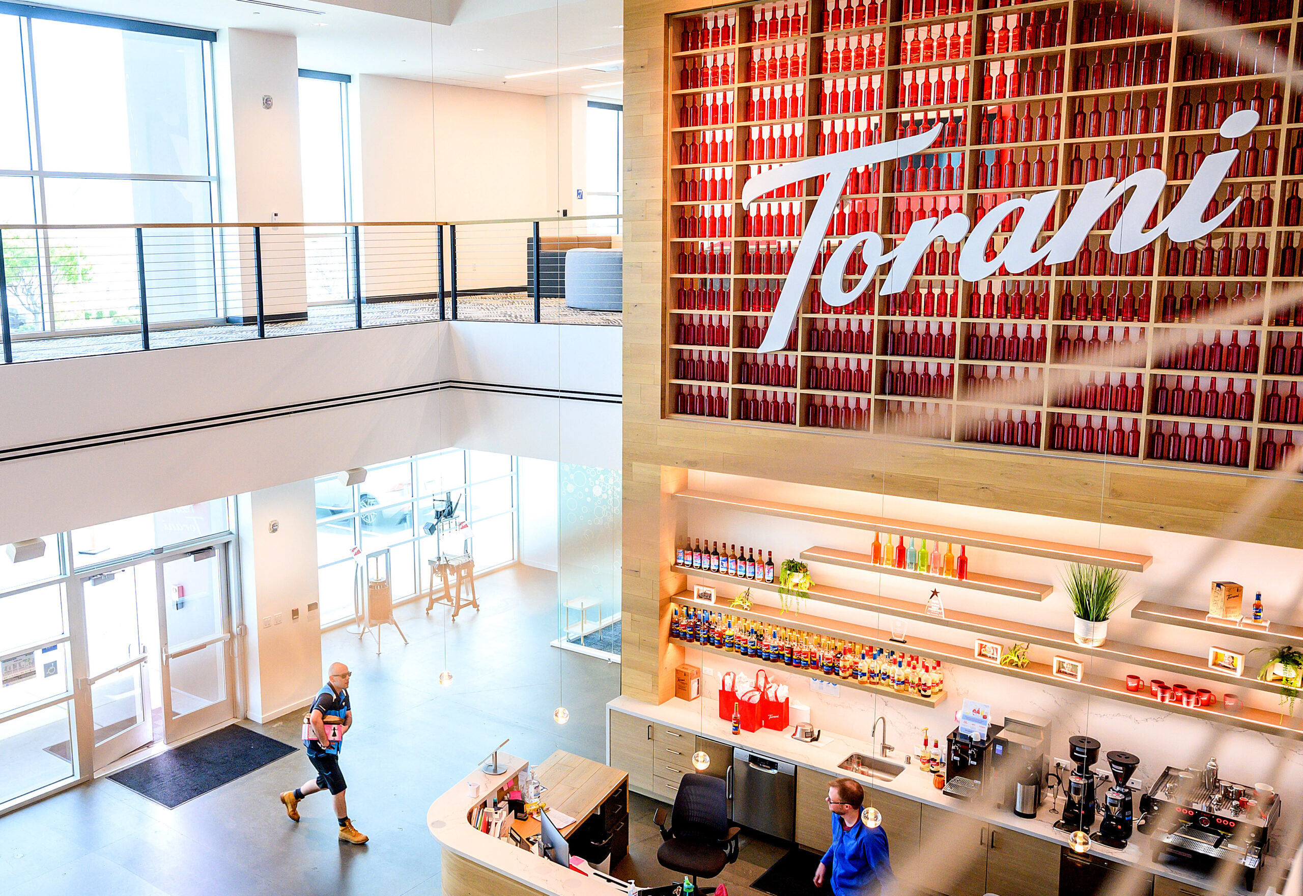 An image shows the lobby of a large office building with a sign that says &quot;Torani.&quot; 