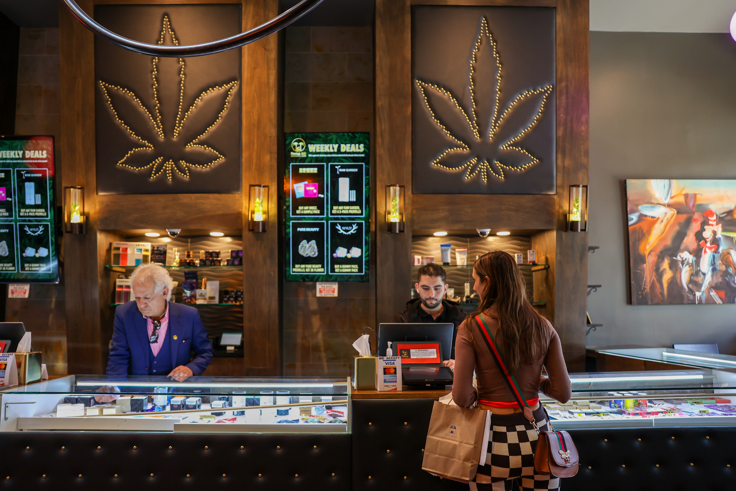 The interior of a cannabis shop with customers and employees