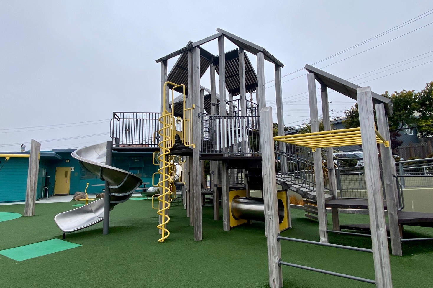 A play structure with astroturf.