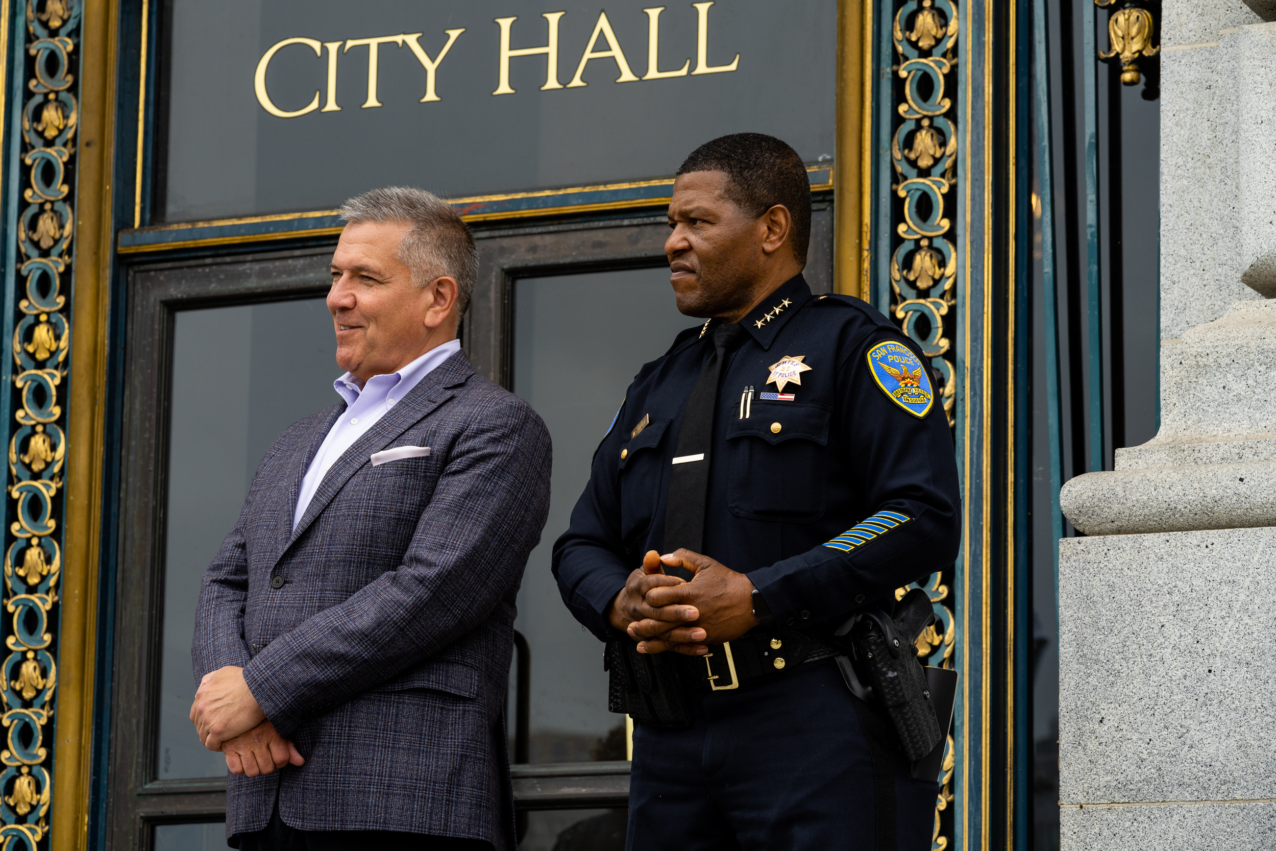 Supervisor Matt Dorsey and Chief of Police Bill Scott stand on the steps of San Francisco City Hall