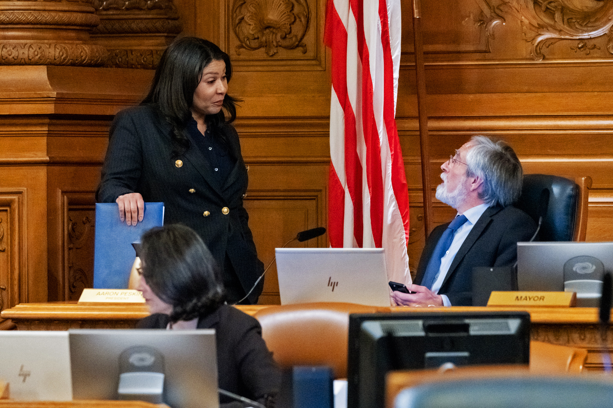 Mayor London Breed, left, and Board of Supervisors President Aaron Peskin chat before a board meeting at San Francisco City Hall on March 7, 2023.