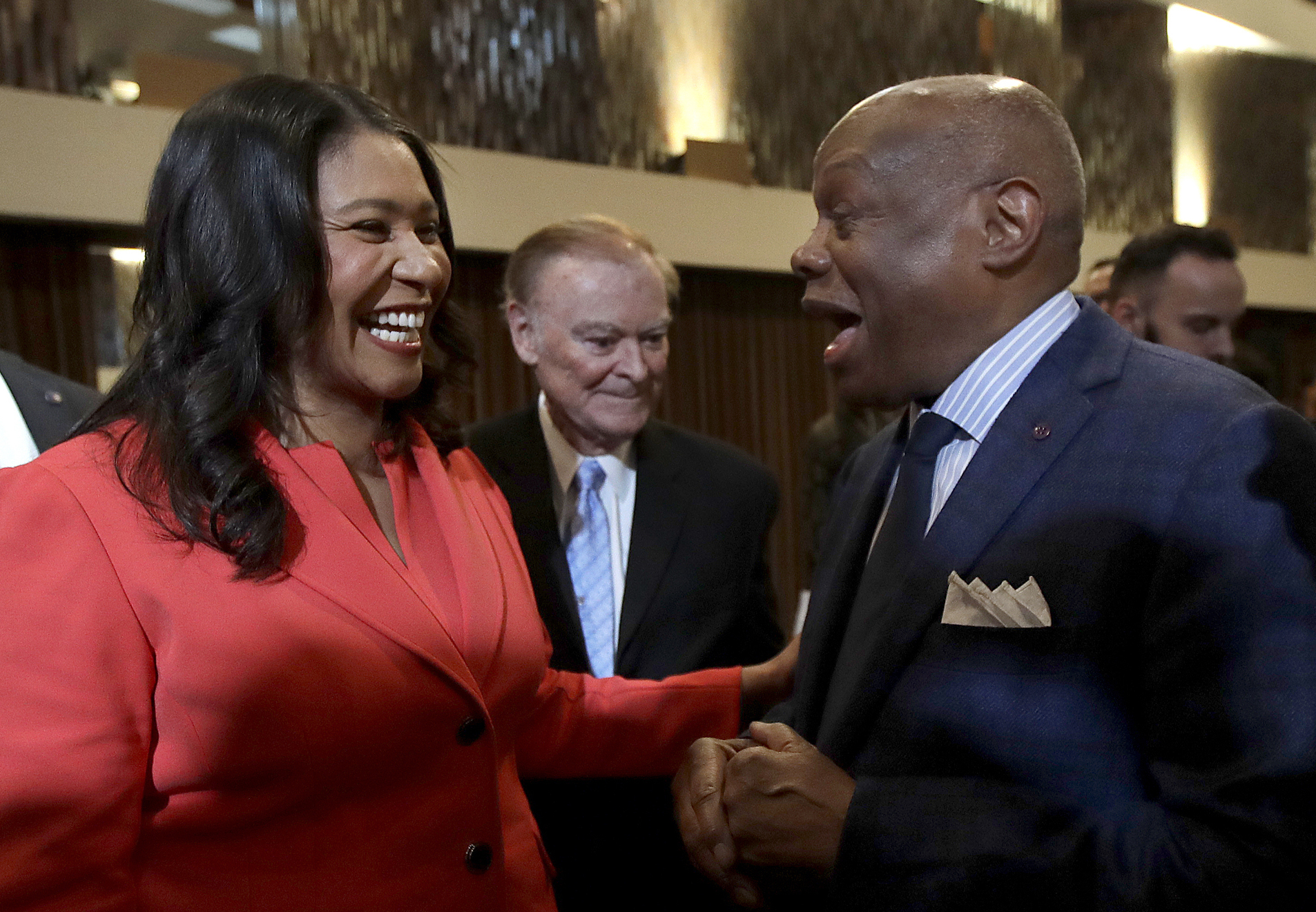 San Francisco Mayor London Breed, left, and former Mayor Willie Brown share a laugh after Breed delivered her State of the City address in San Francisco on Jan. 30, 2019. 