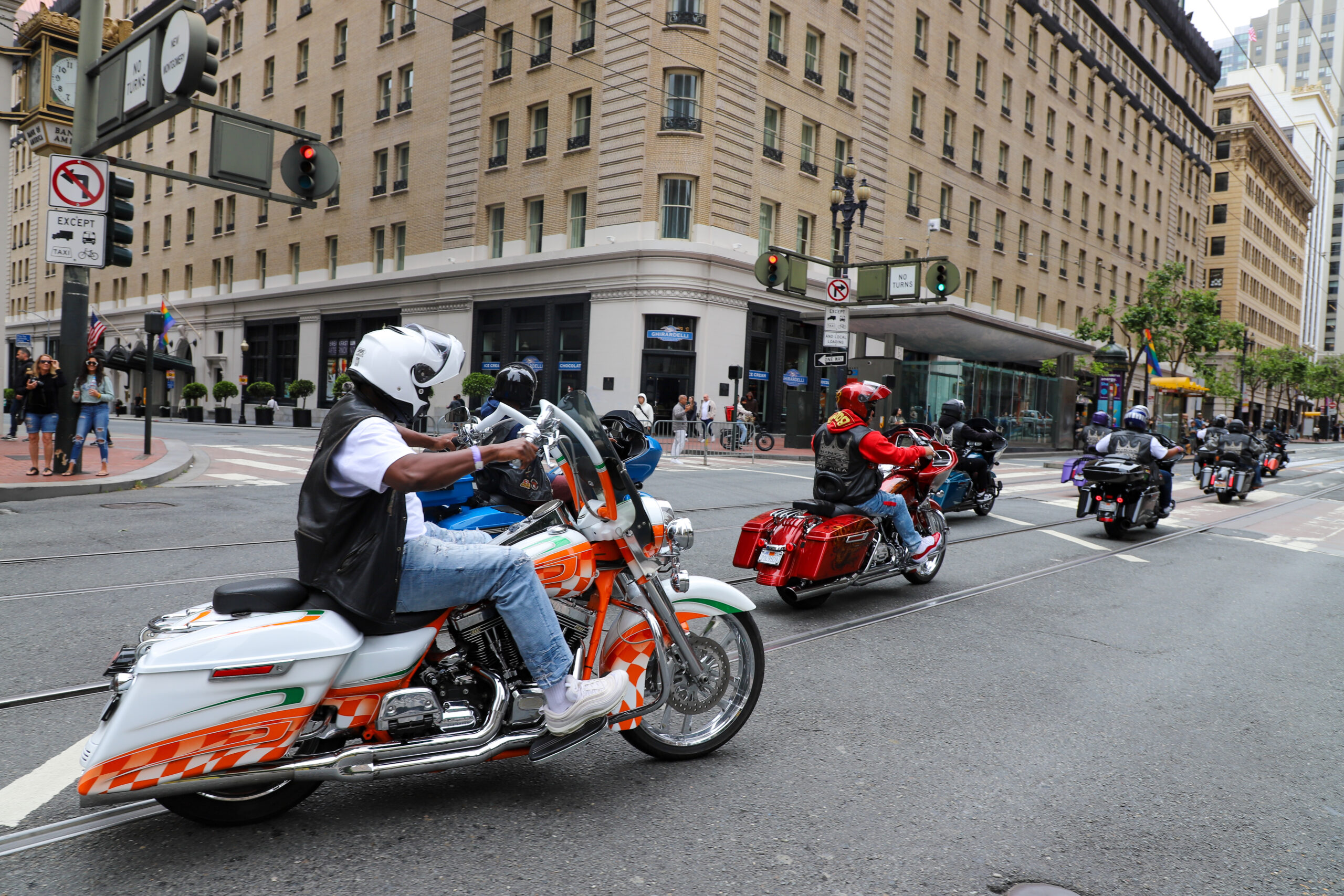 Motorcyclists riding in a city.