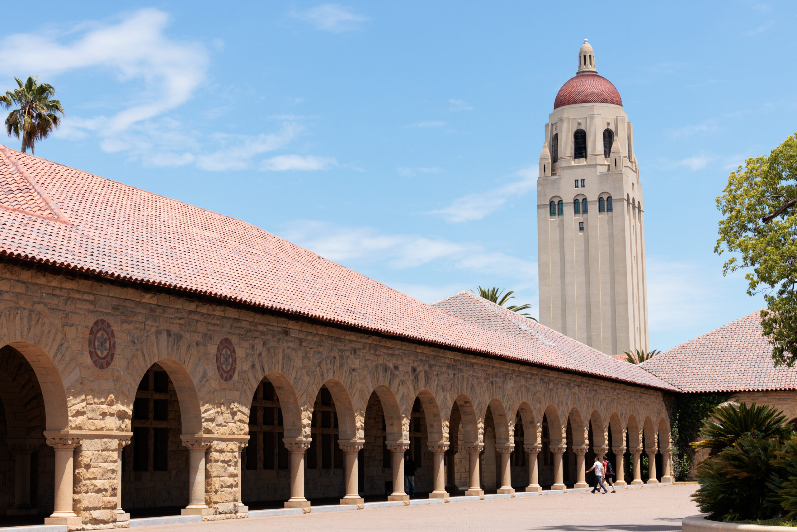 The Hoover Tower is viewed from the Main Quad at Stanford University on a sunny day.