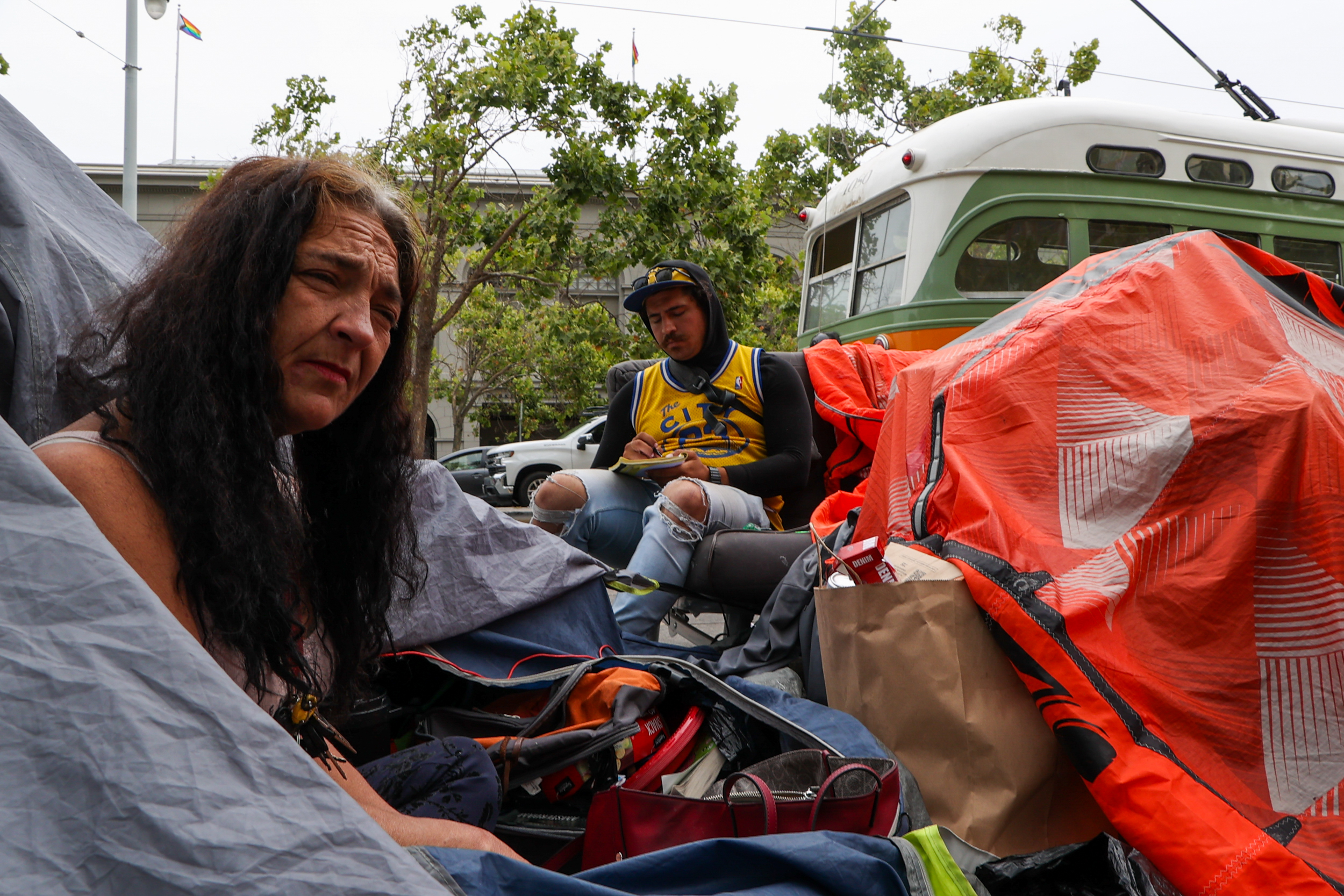 Two people at a homeless encampment in San Francisco
