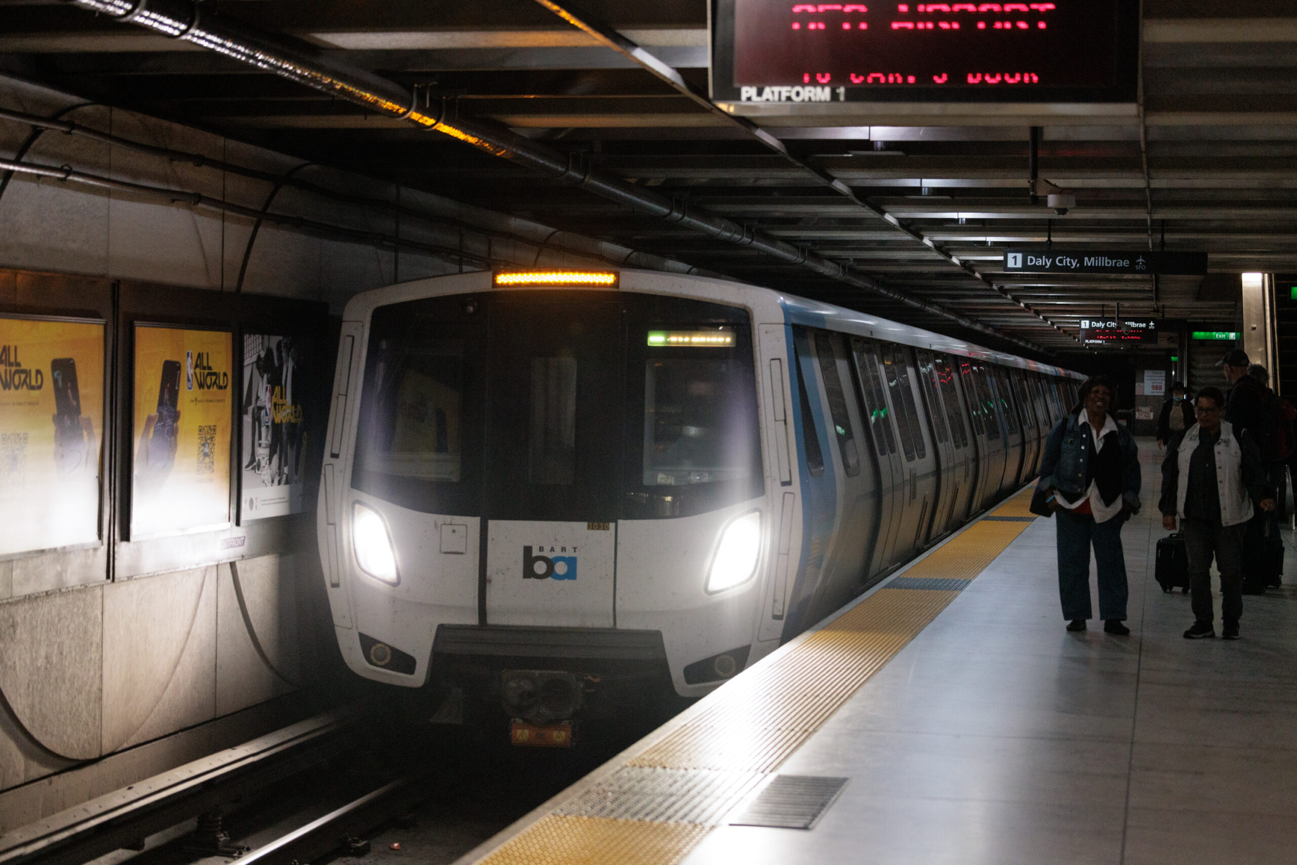 a bart train is seen in a dark tunnel at a station