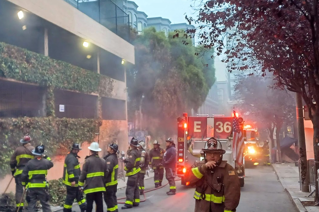 firefighters gather in an alleyway