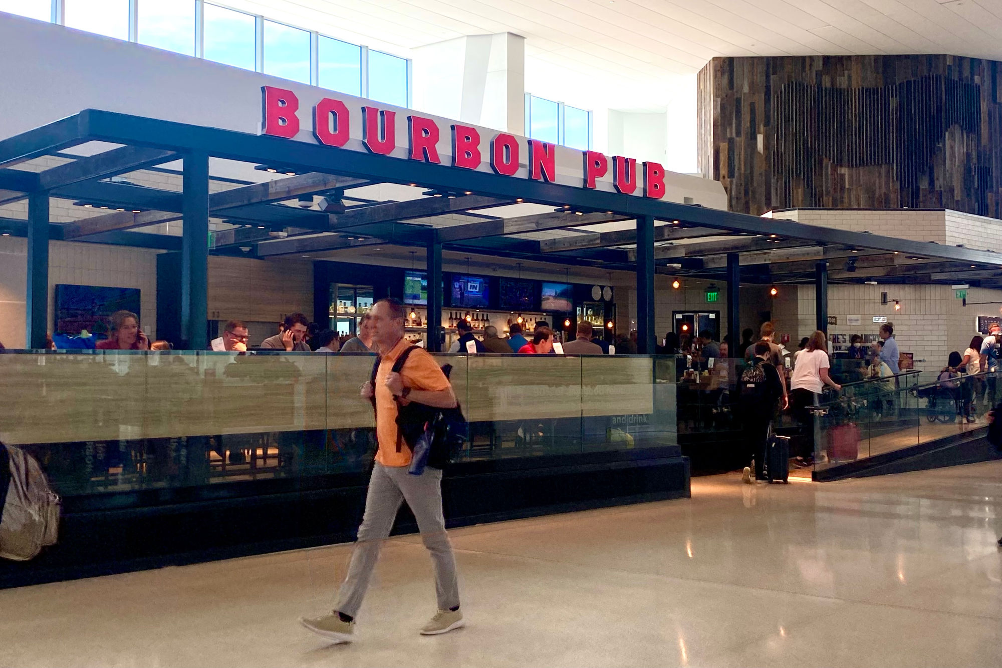 Man walks past restaurant Bourbon Pub at San Francisco International Airport
