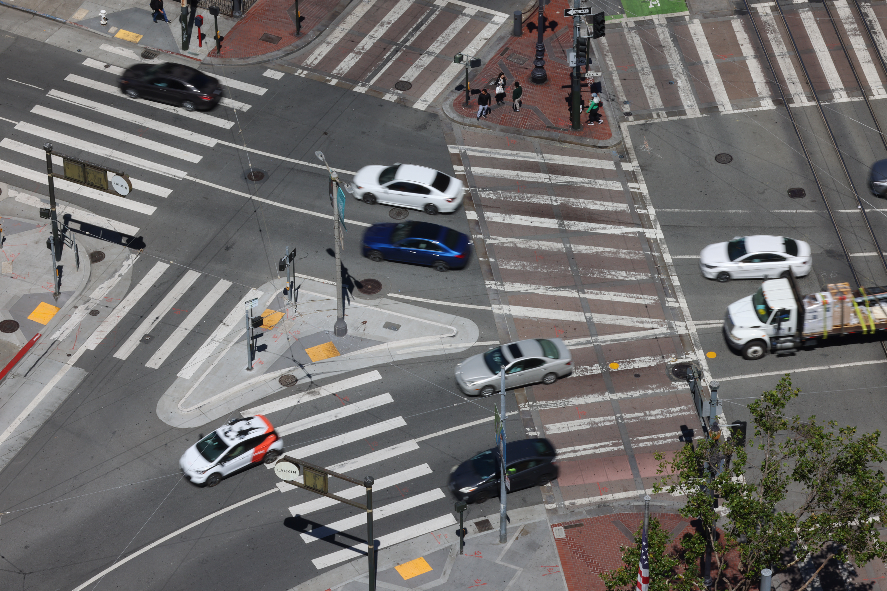 An intersection of Market Street seen from above with cars on it.