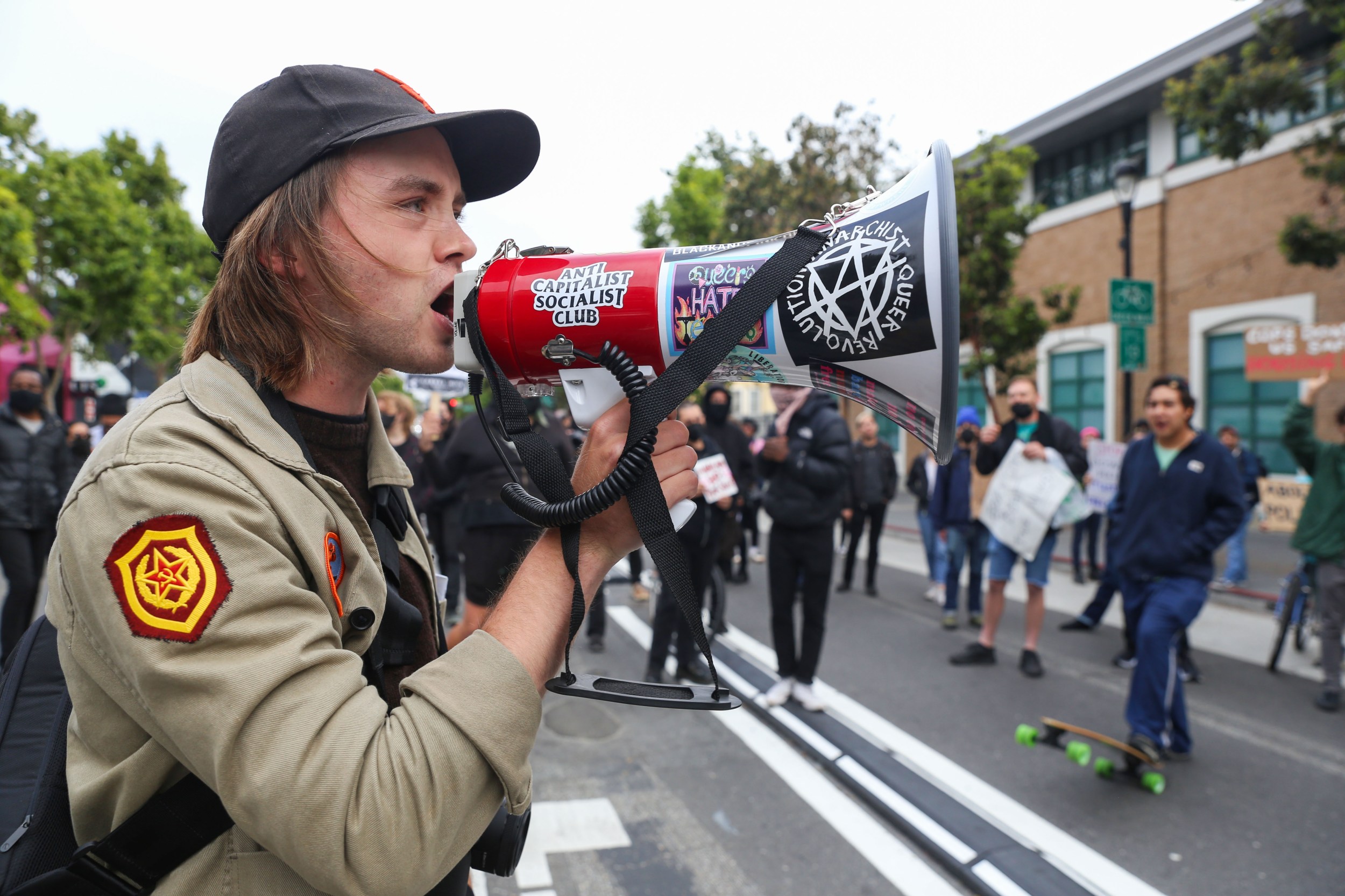 A man with a bullhorn yells during a protest in San Francisco.