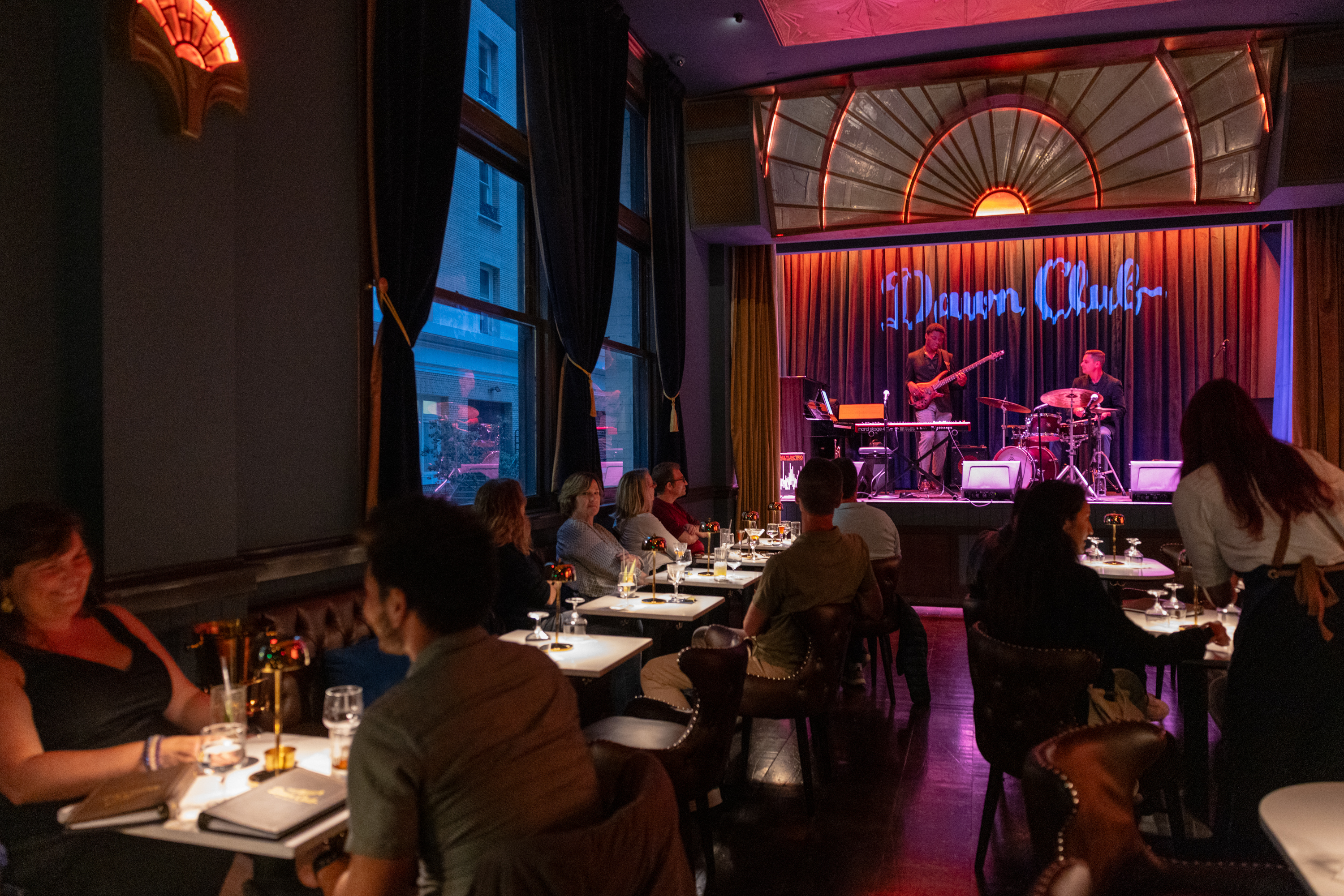 Guests enjoy drinks and live music from the jazz band at the Dawn Club in San Francisco.