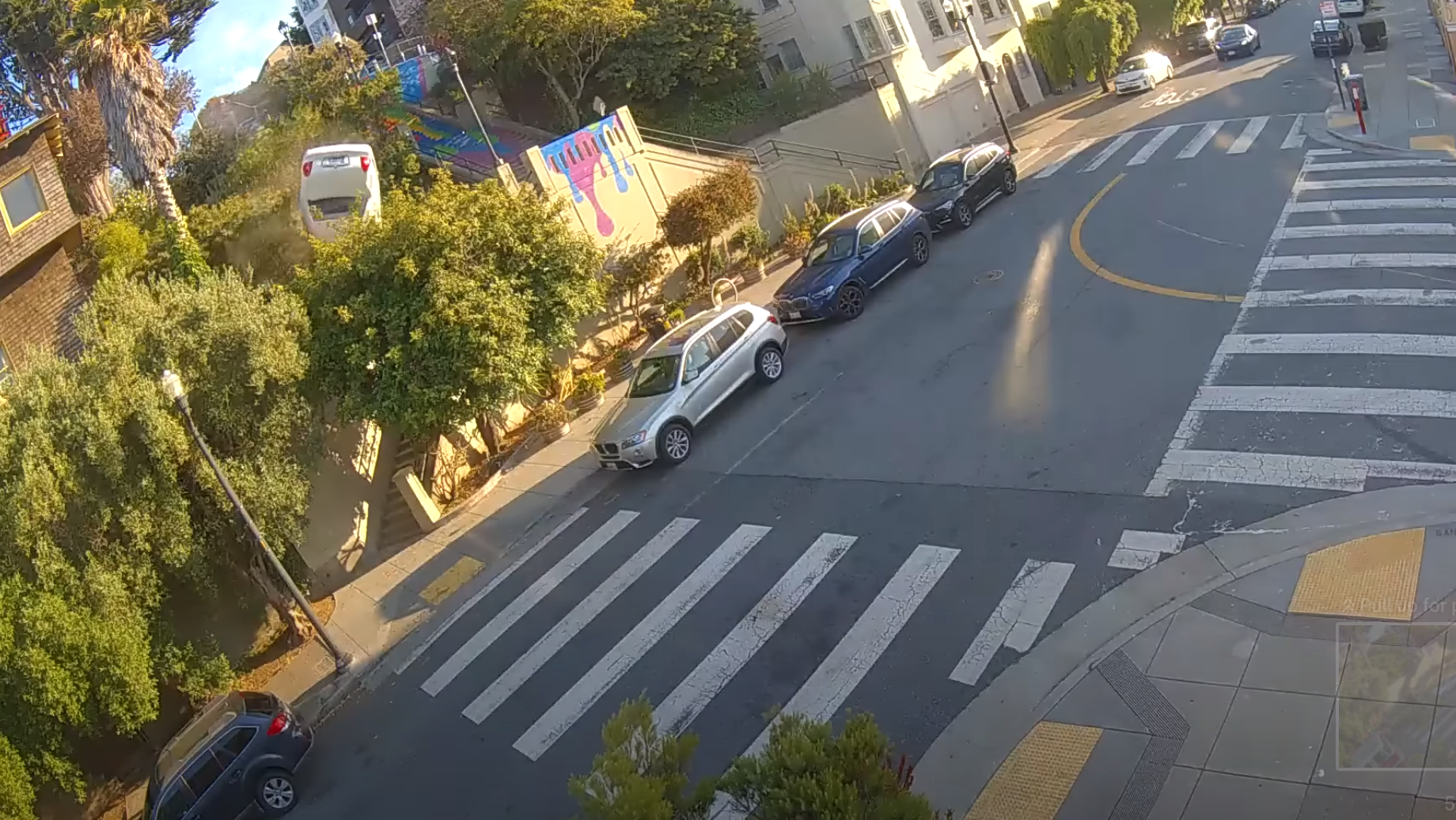 A white vehicle tumbles downhill Saturday from the top of the Sanchez Stairs at 19th and Sanchez streets in San Francisco. | Courtesy Julia Brown @JuliaBrownSF via YouTube