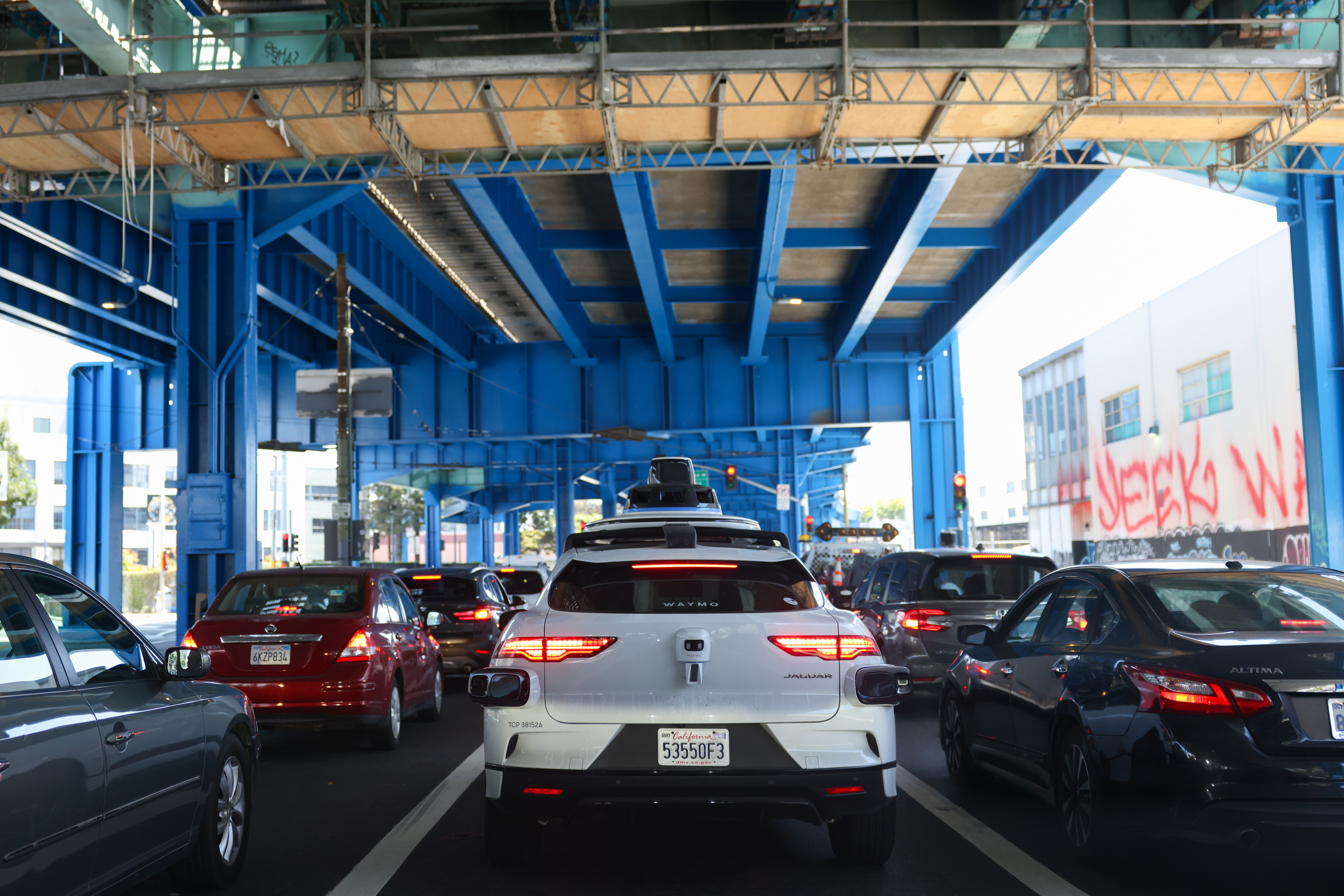 A driverless Waymo car drives down 13th Street, in San Francisco on Tuesday, July 18, 2023. The self-driving vehicles travel slower than their manned-counterparts, are very cautious when it comes to left turns and have a surprising amount of maneuverability. | Jeremy Chen/The Standard