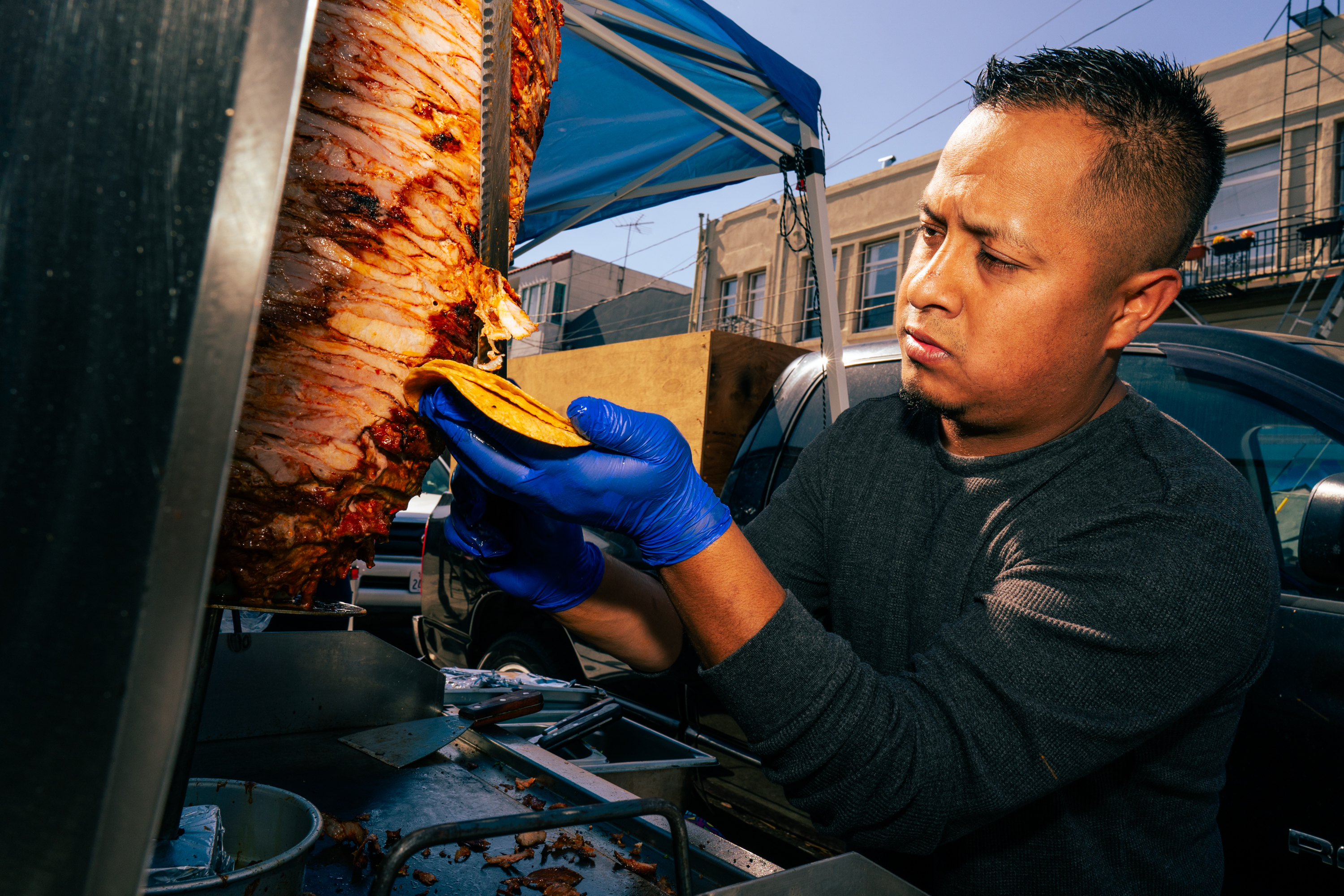 Juan Lazaro prepares and cuts the al pastor for Tacos El Charro