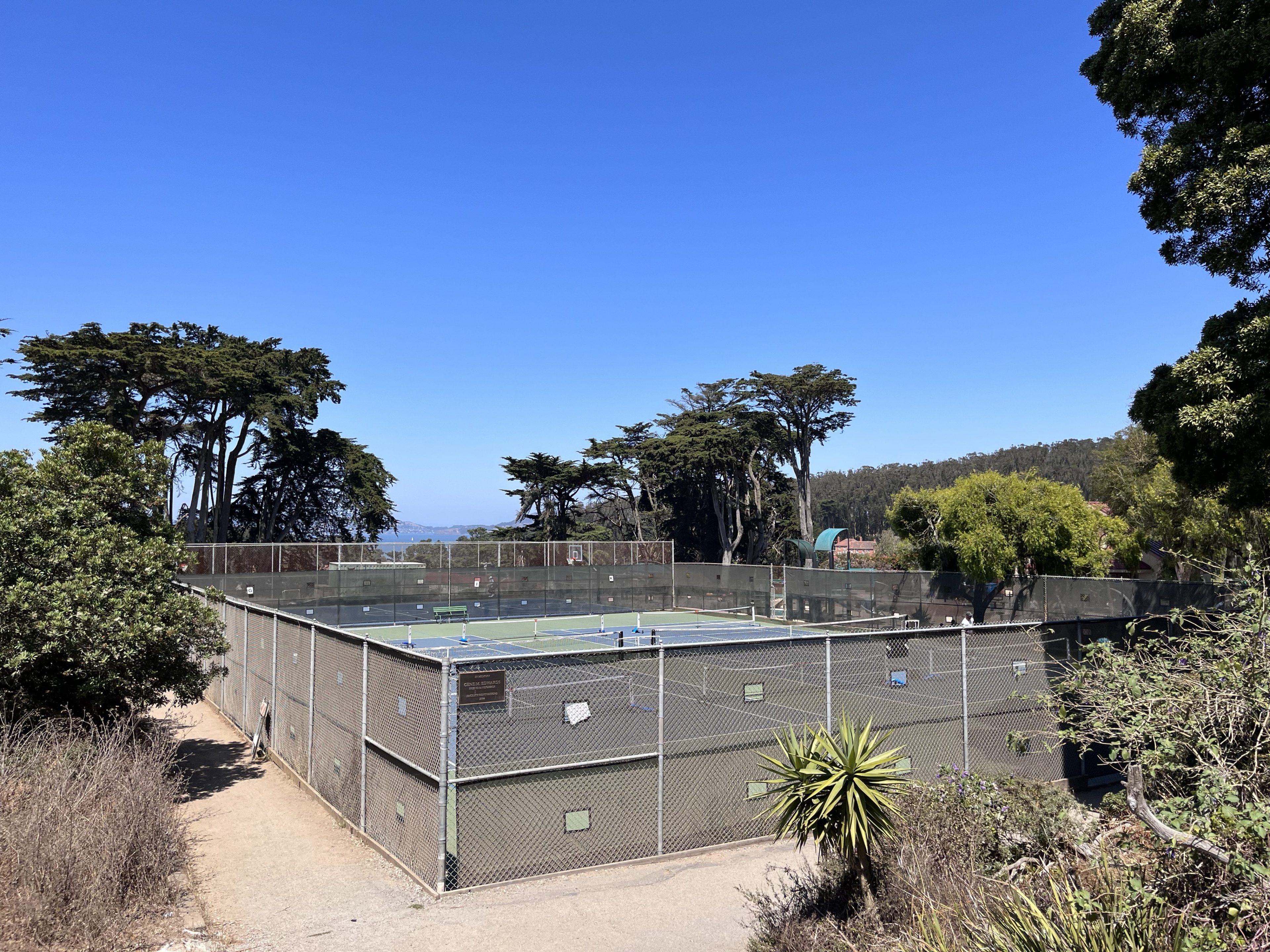 An exterior of the Presidio Wall pickleball courts in San Francisco on a sunny day.