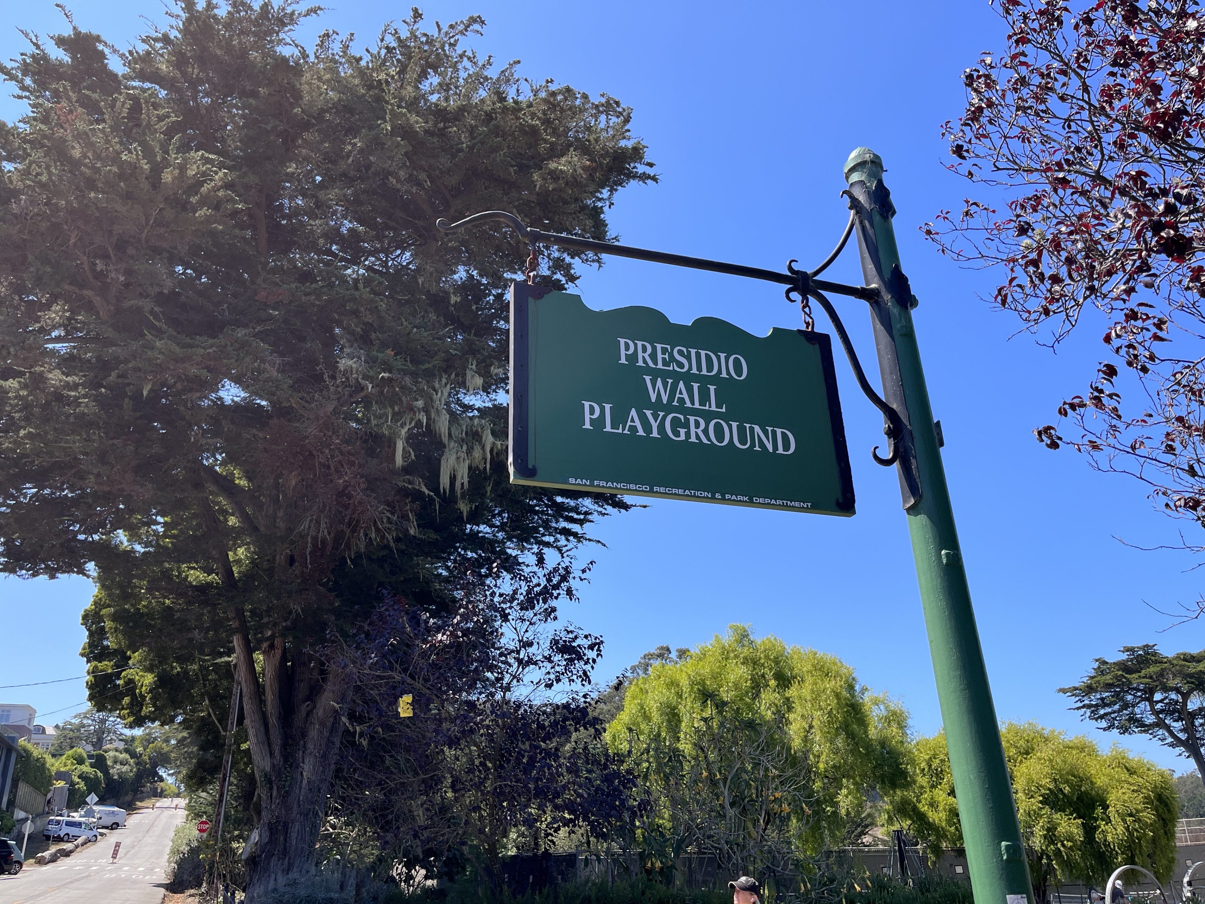 A sign shows the name of Presidio Wall Playground park in San Francisco. 