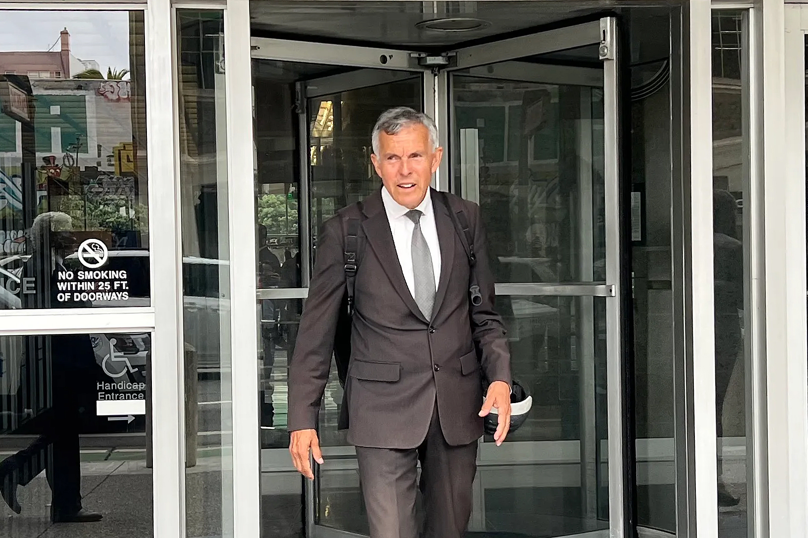 A man walks out of a court building.