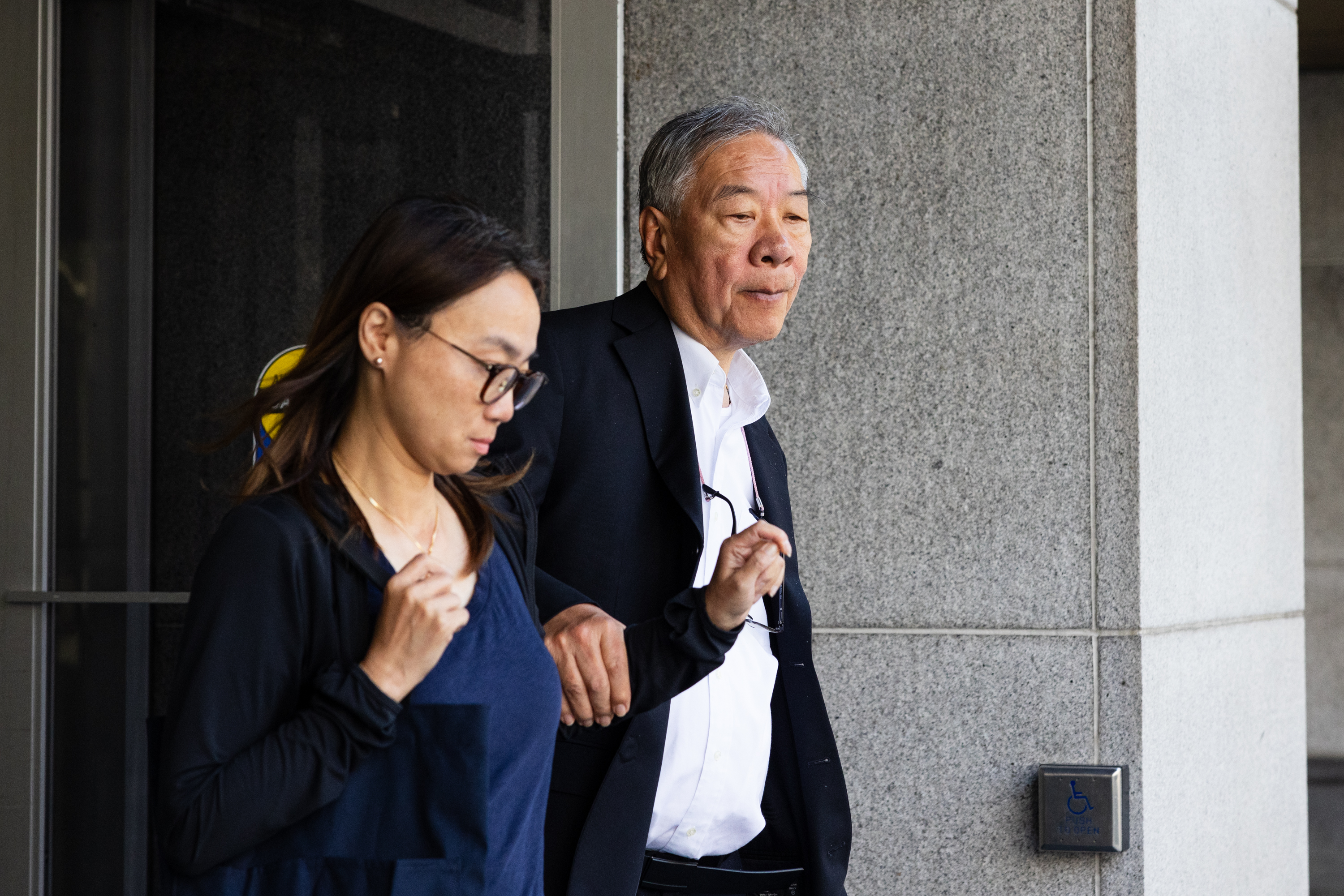 Walter Wong exits the court house with an unknown person.