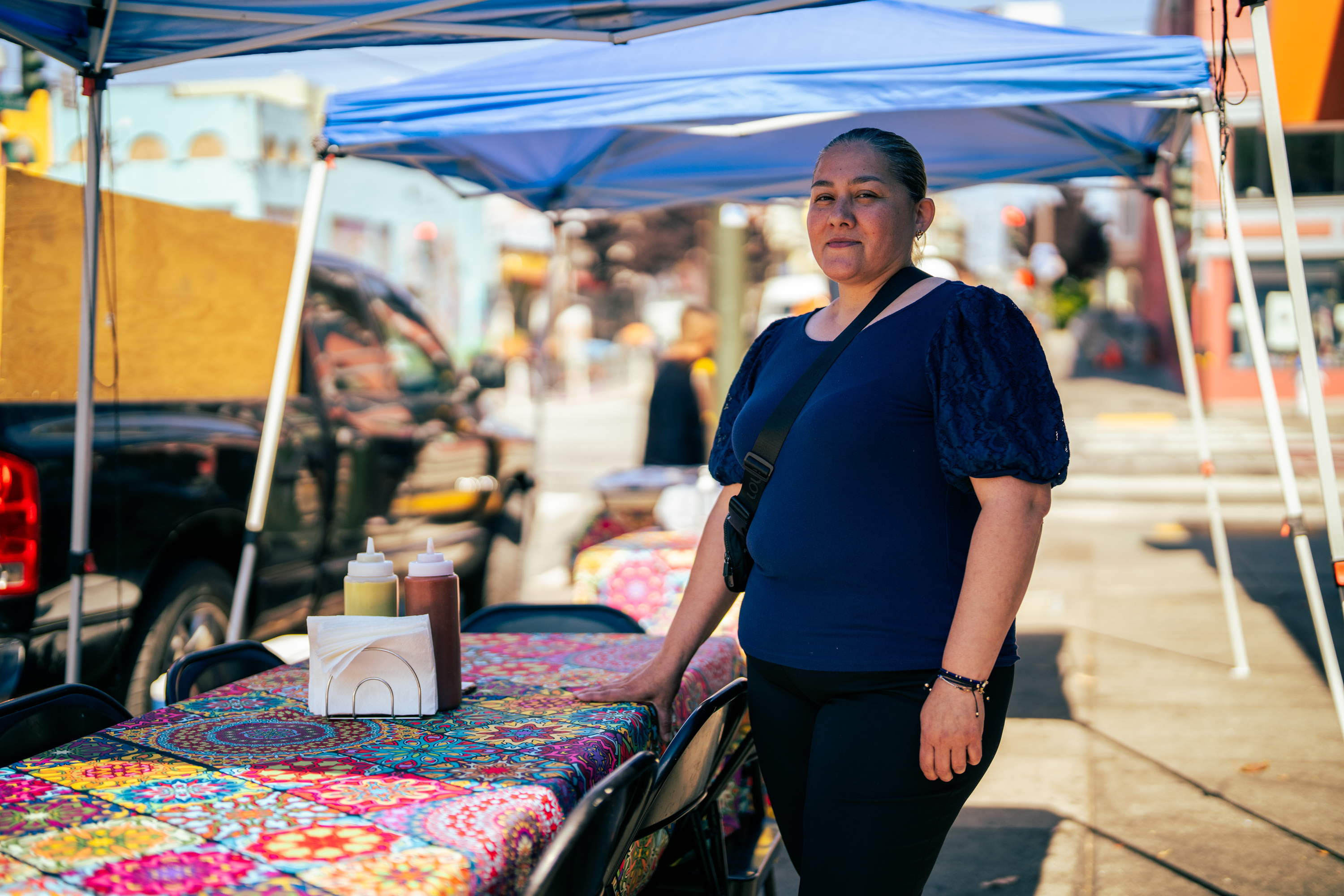 Owner Carina Montoya poses besides Tacos El Charro food stand.