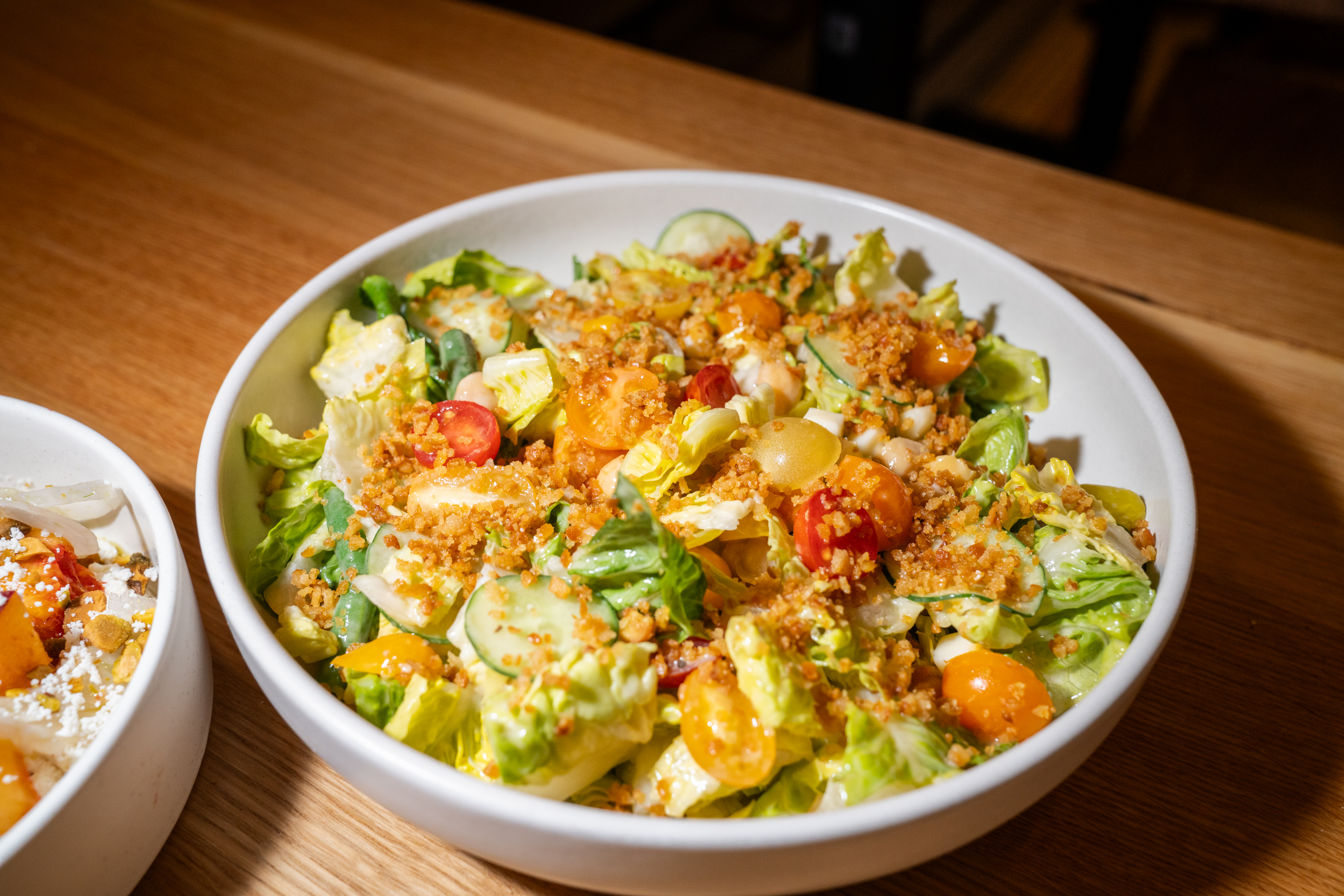A summer chop salad features market veggies, chickpeas, pepperoncini, parm frico and creamy Italian dressing.