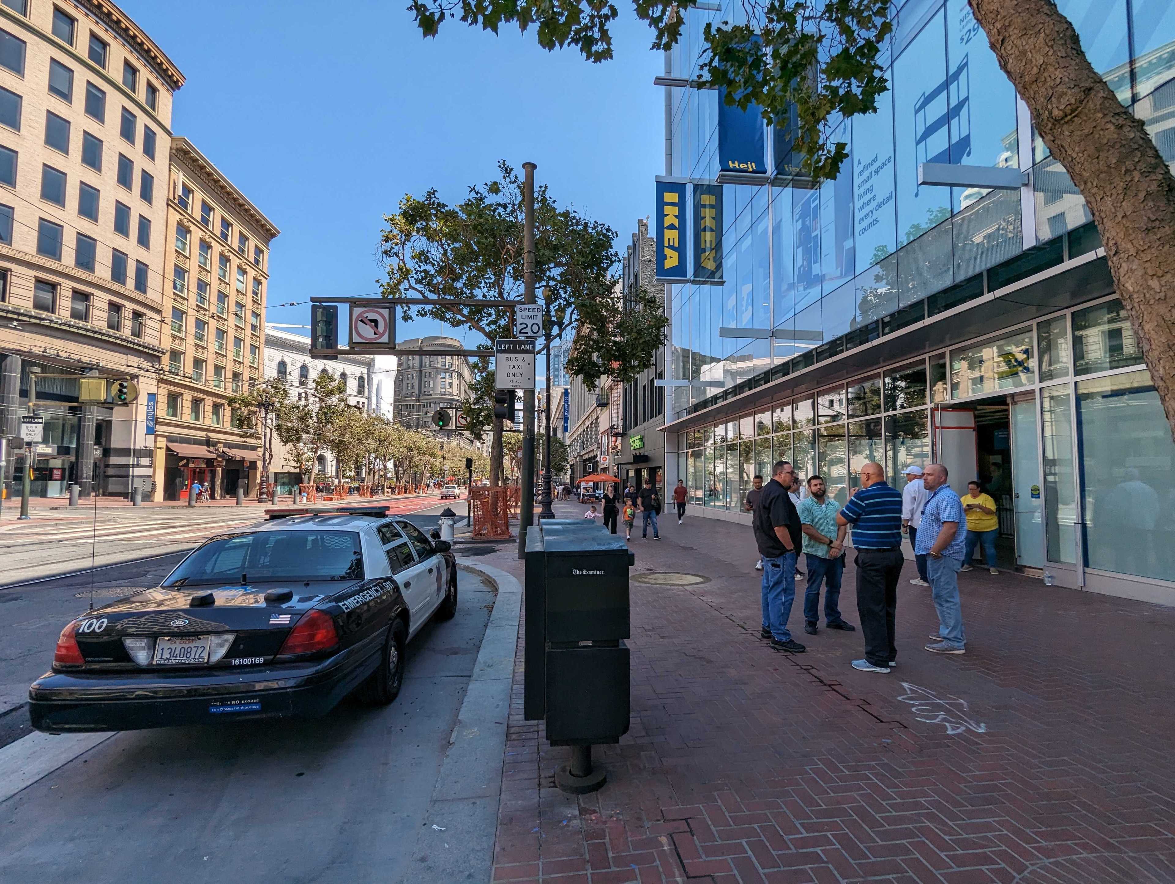 As 'friends and family' Ikea store members pay a weekend sneak-peek visit Sunday, Aug. 20, 2023 to its mid-Market Street location due to open Wednesday, a San Francisco Police Department patrol car is parked nearby. | George Kelly/The Standard