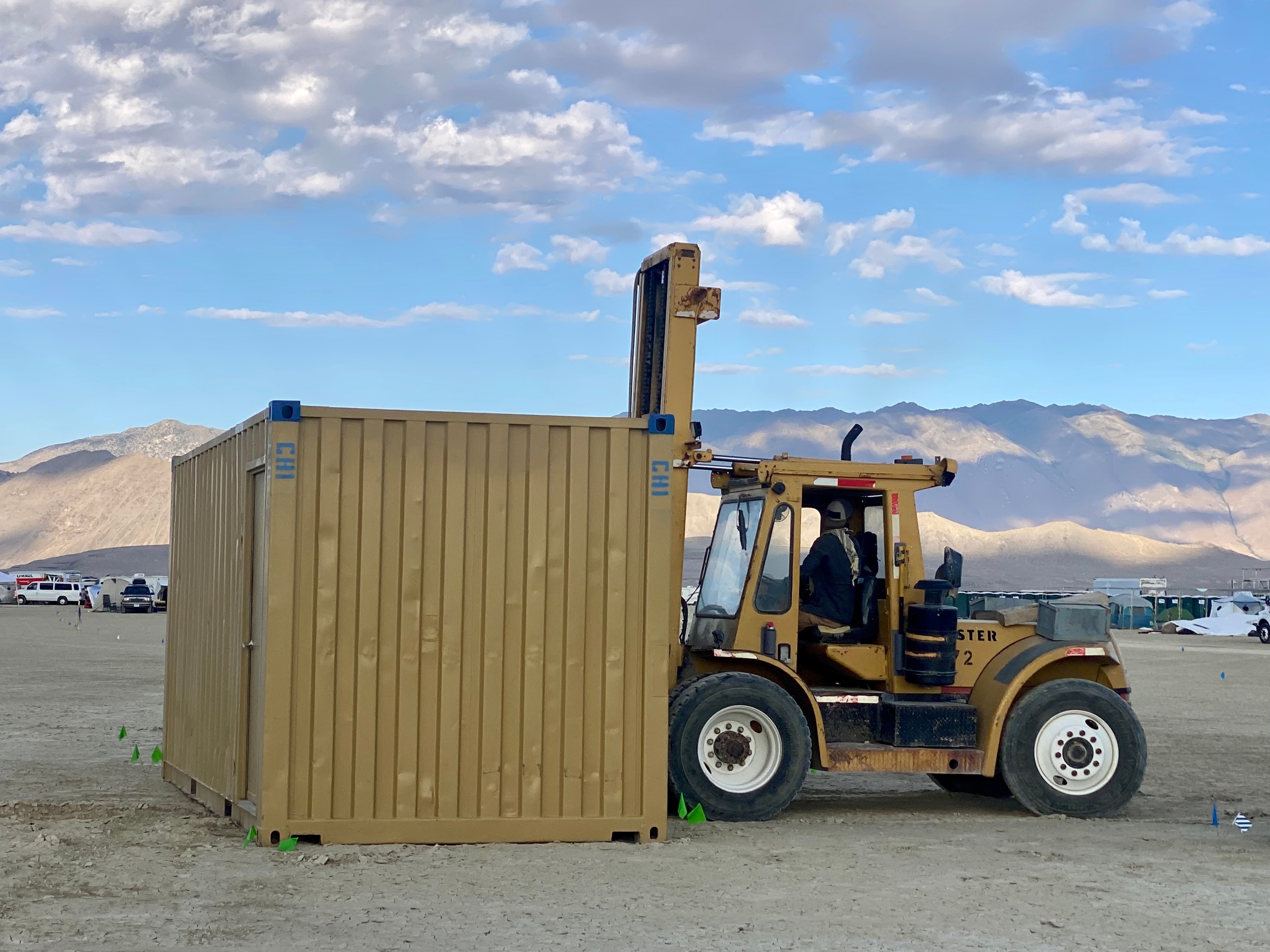 A forklift is used to move a container at Burning Man on Aug. 25, 2023.