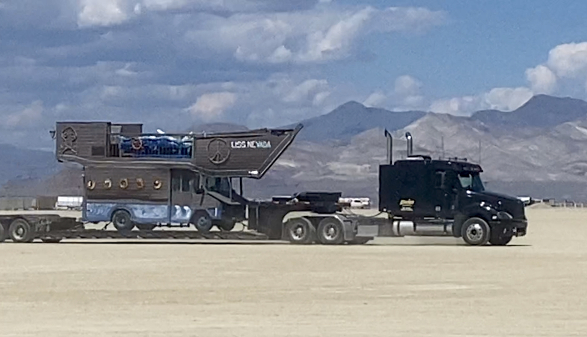 A truck driver hauls the base for the Gallavant camp’s USS Nevada pirate ship into Black Rock City on Aug. 25, 2023 as part of Burning Man 2023.