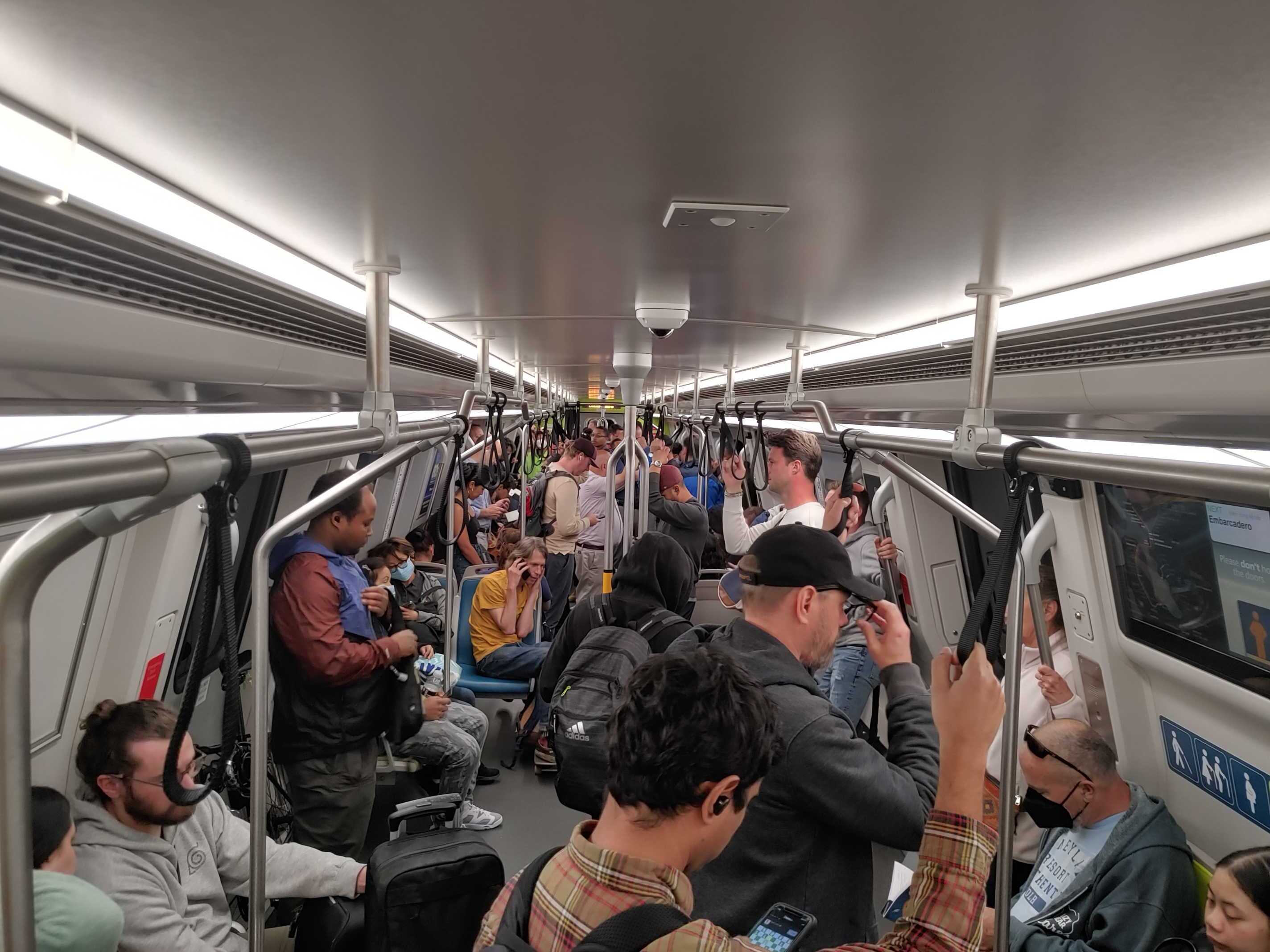 Passengers cram into a subway car.
