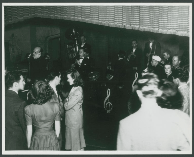 Guests are seen listening to a live band at the Dawn Club in its former iteration.
