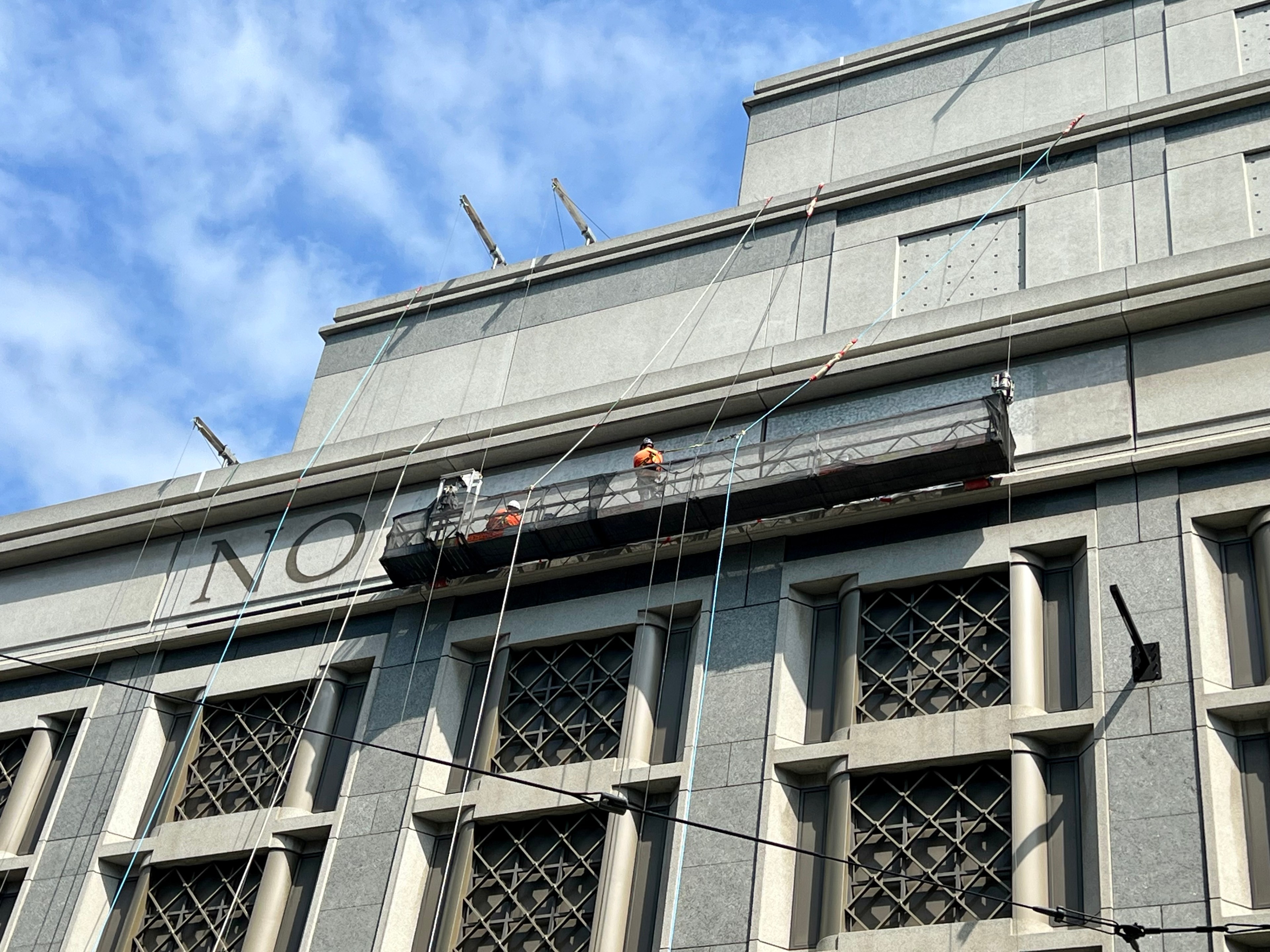 Workers remove lettering from Nordstrom's sign at the mall in Downtown San Francisco.