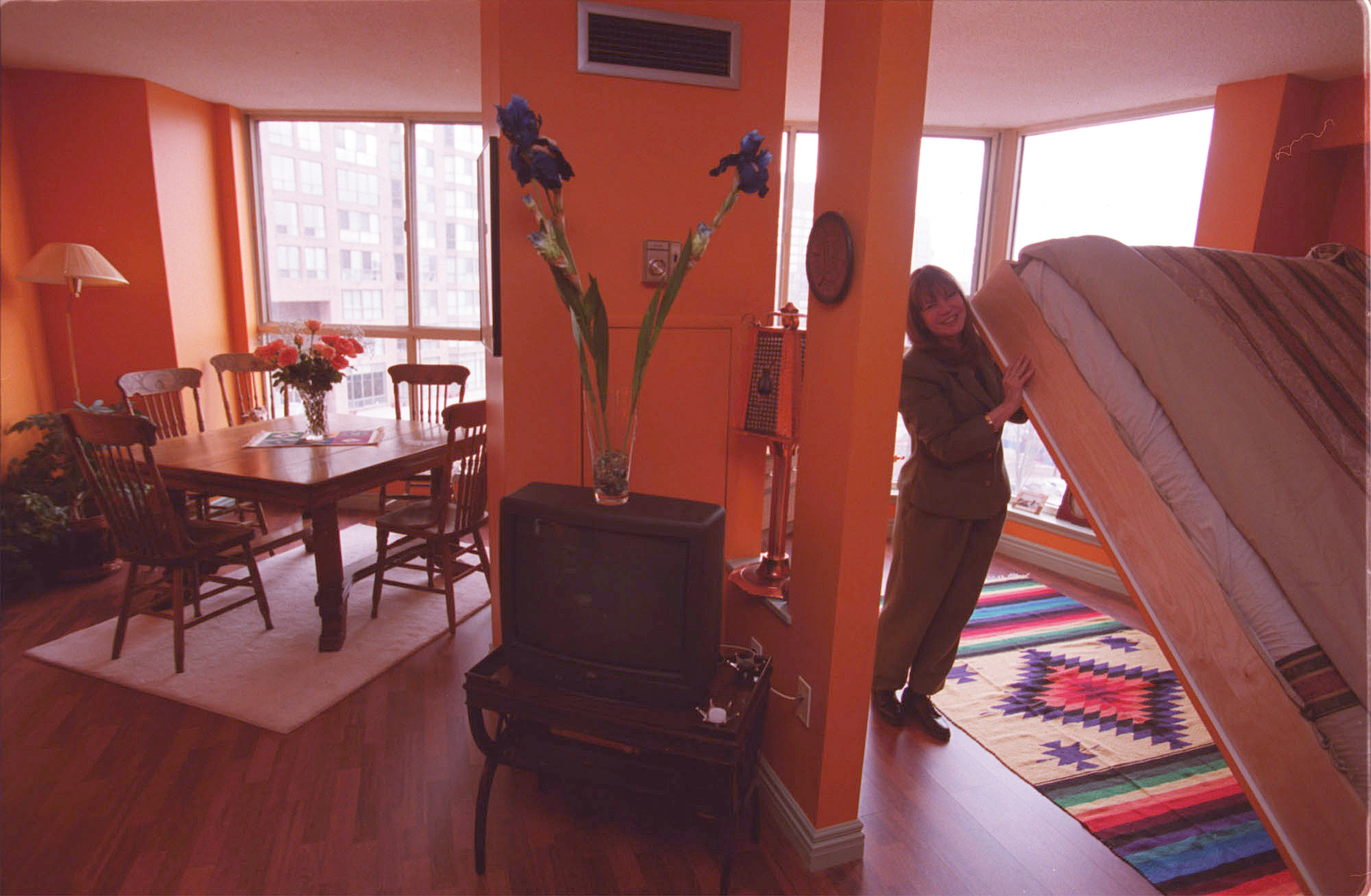 A person demonstrates how to use a Murphy bed