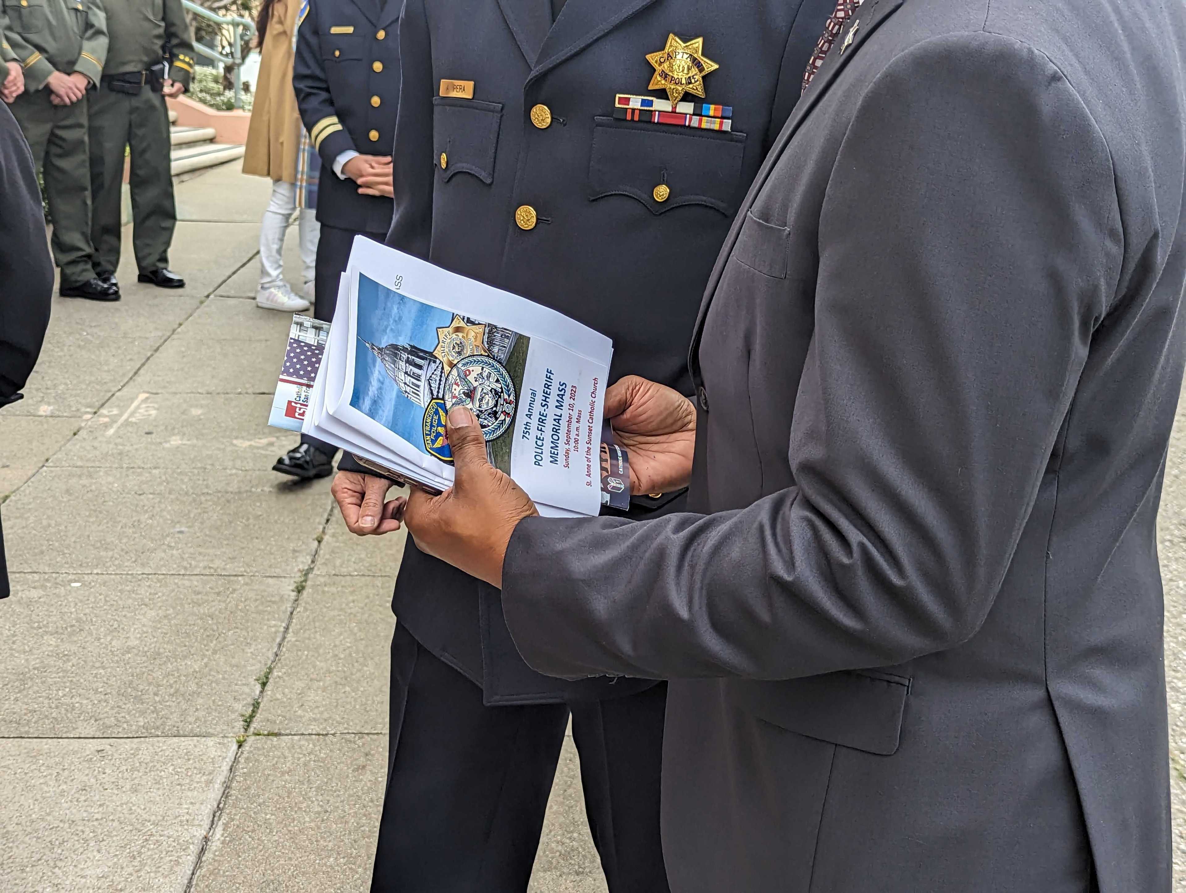 San Francisco sheriff's deputies and a San Francisco police captain stand outside St. Anne of the Sunset Catholic Church, 850 Judah St., before Sunday's 75th annual Police-Fire-Sheriff Memorial Mass.