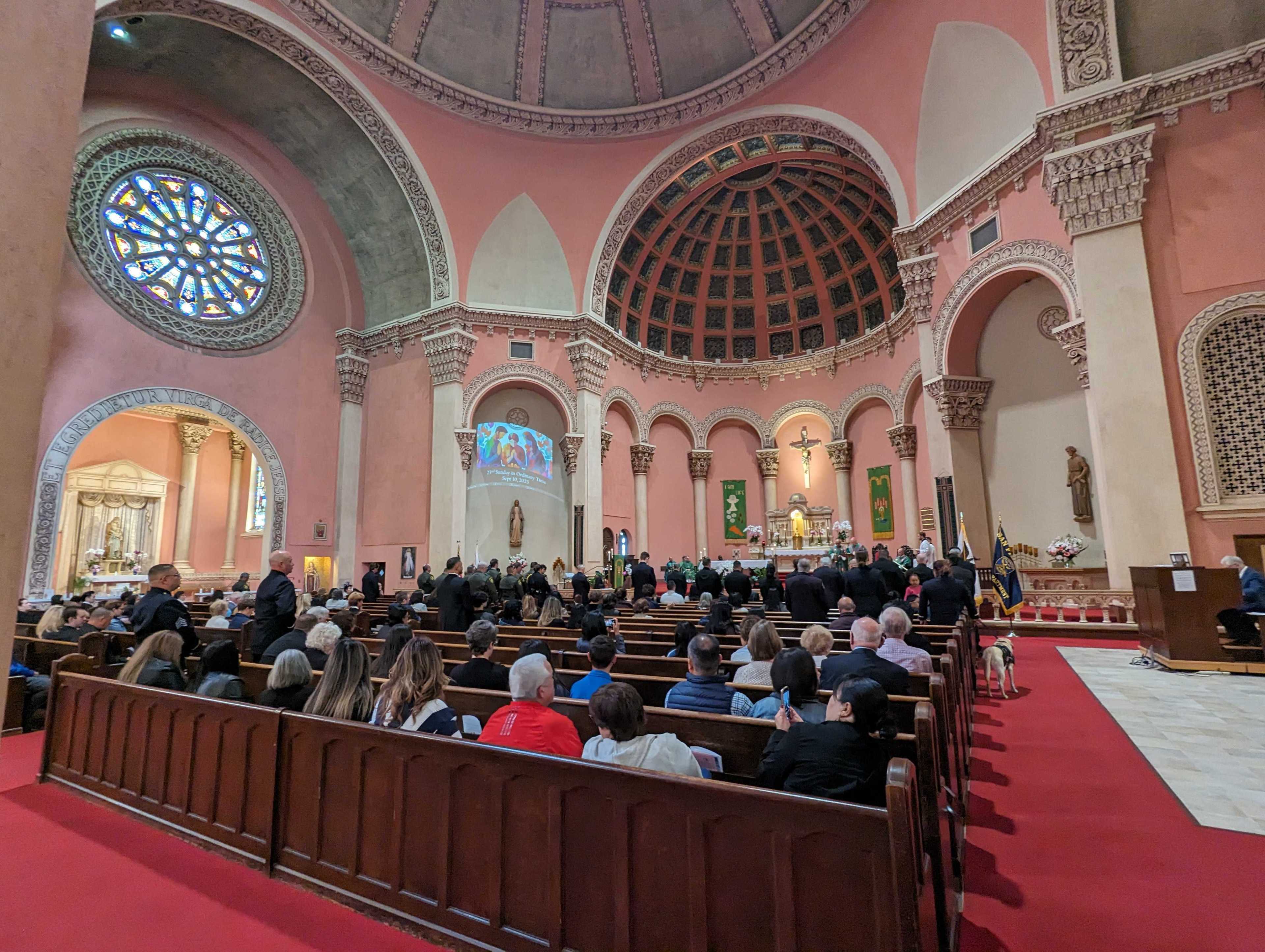 City police, firefighters and sheriff's deputies stand inside St. Anne of the Sunset Catholic Church, 850 Judah St., at a "blessing of the badges" ceremony during Sunday's 75th annual Police-Fire-Sheriff Memorial Mass.