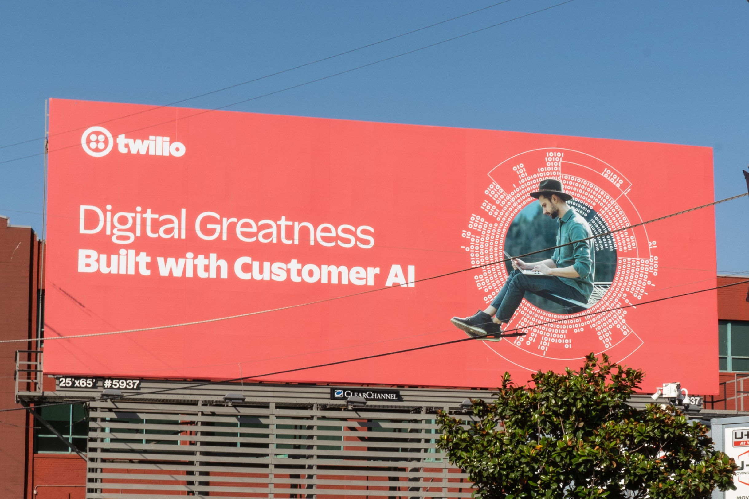 A Twilio billboard is visible from the road as well as from street level in San Francisco