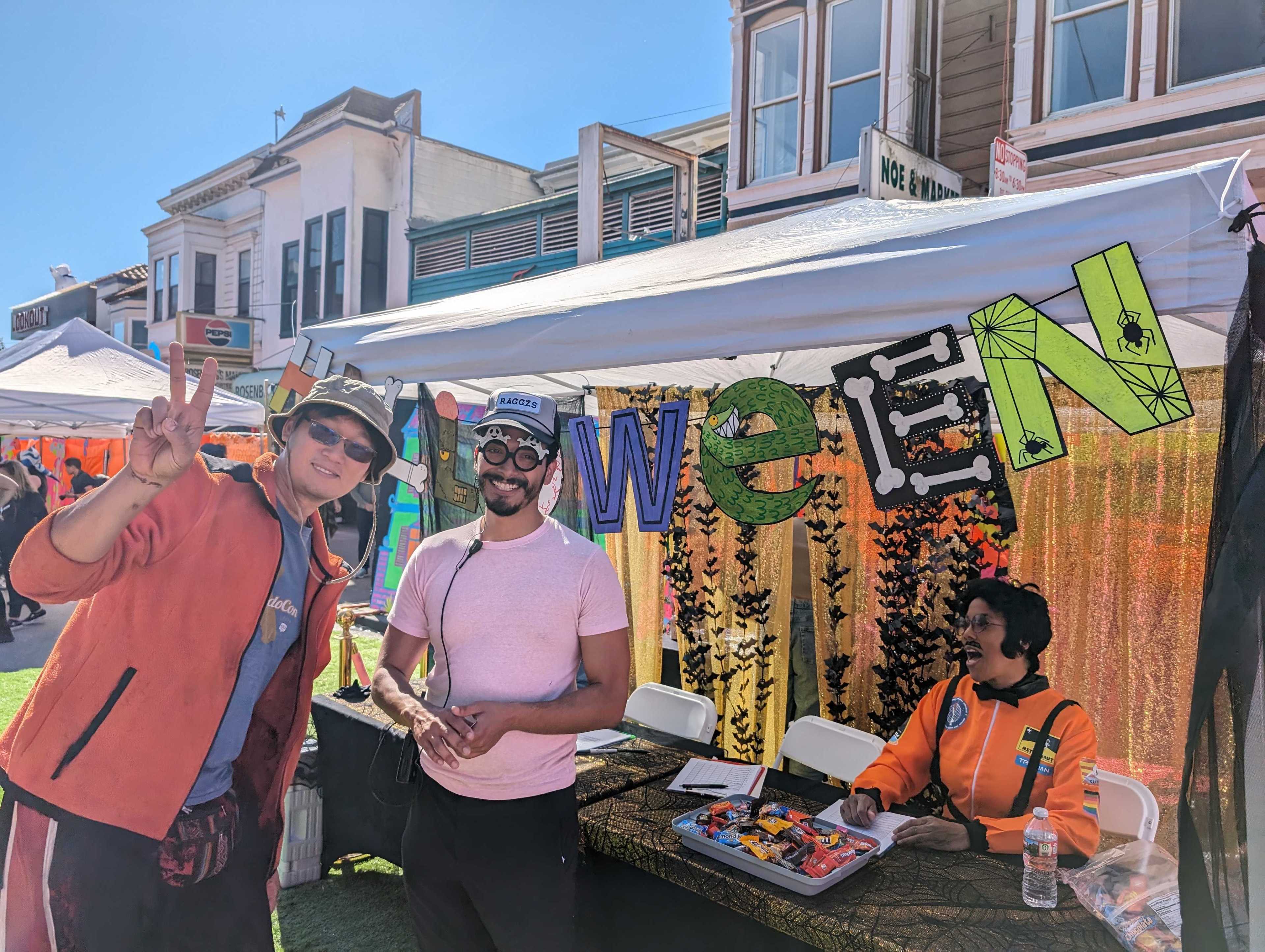 Halloween block party co-organizer Lauro Gonzalez, center, helped keep events on time and on schedule with help from booth workers and friends.