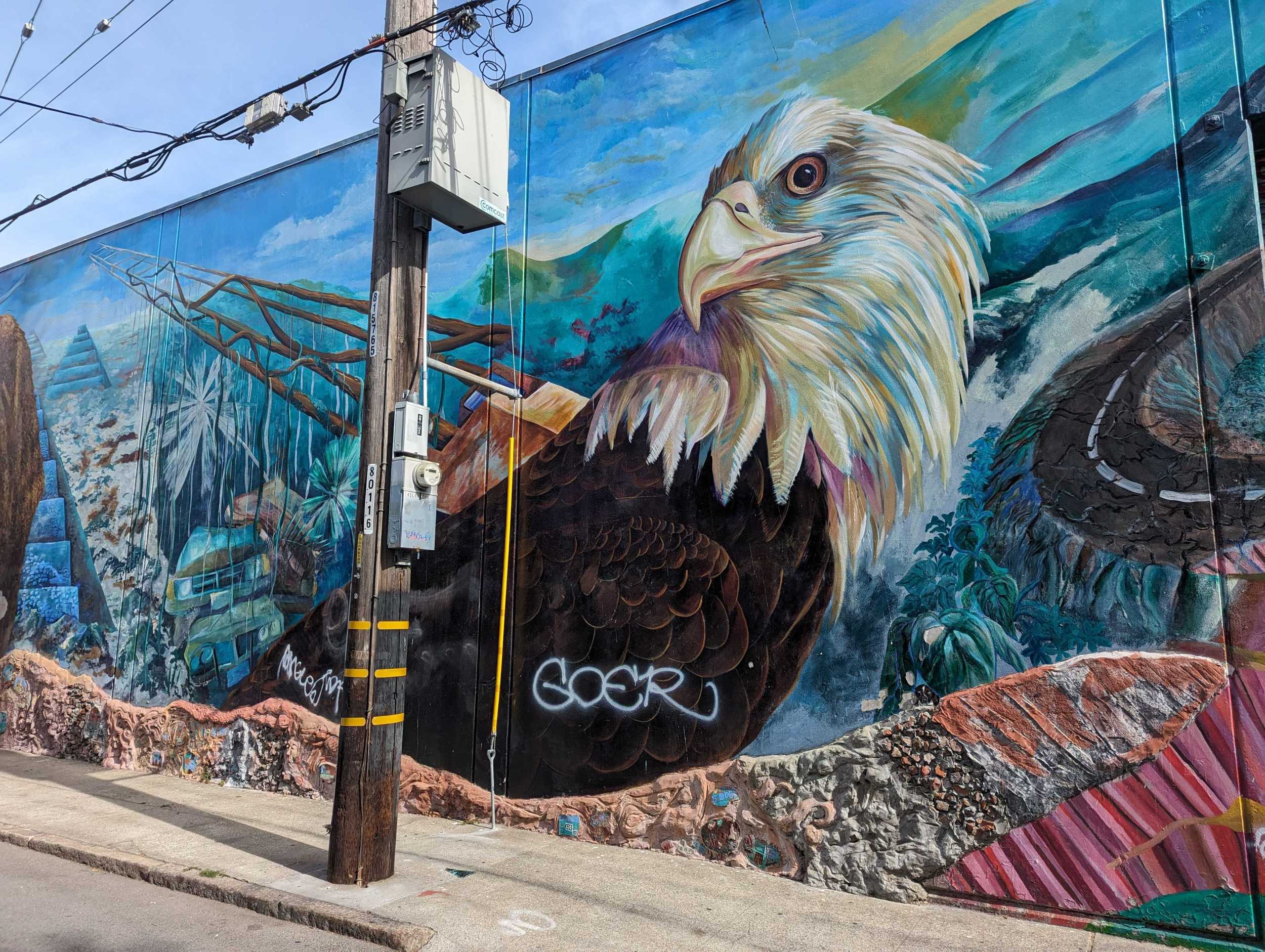 On a Langton Street wall south of Folsom Street in San Francisco's South of Market neighborhood, a gray-spray painted graffiti tag mars a bald eagle's plumage in a neighborhood mural.