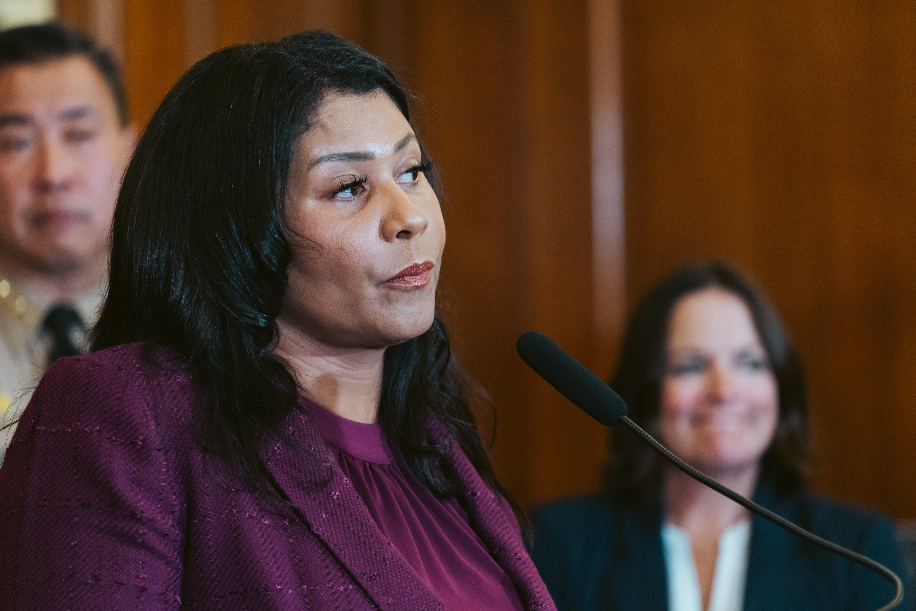San Francisco Mayor London Breed looks on during a press conference at City Hall.