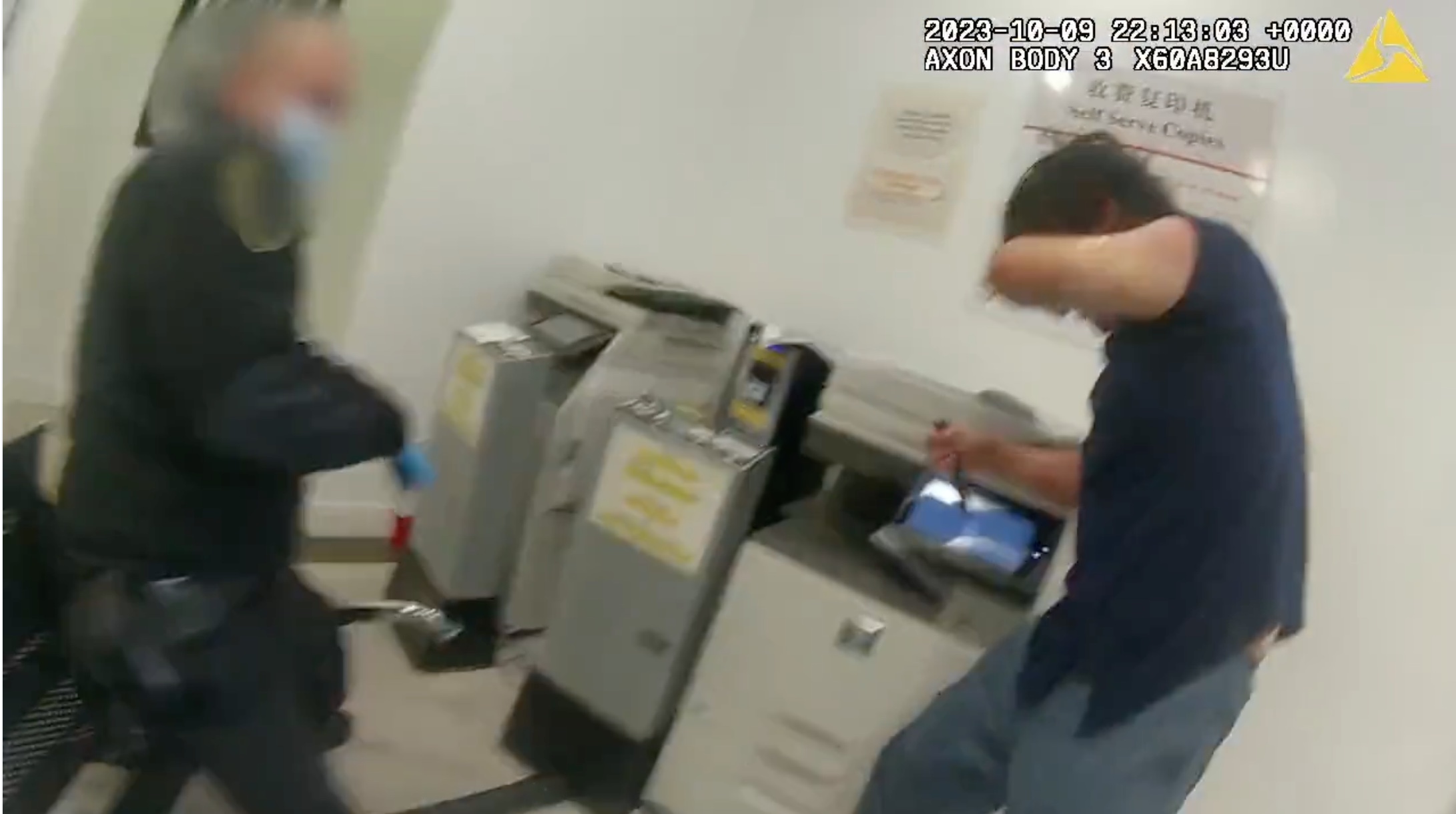 A man swings a knife at a security guard.