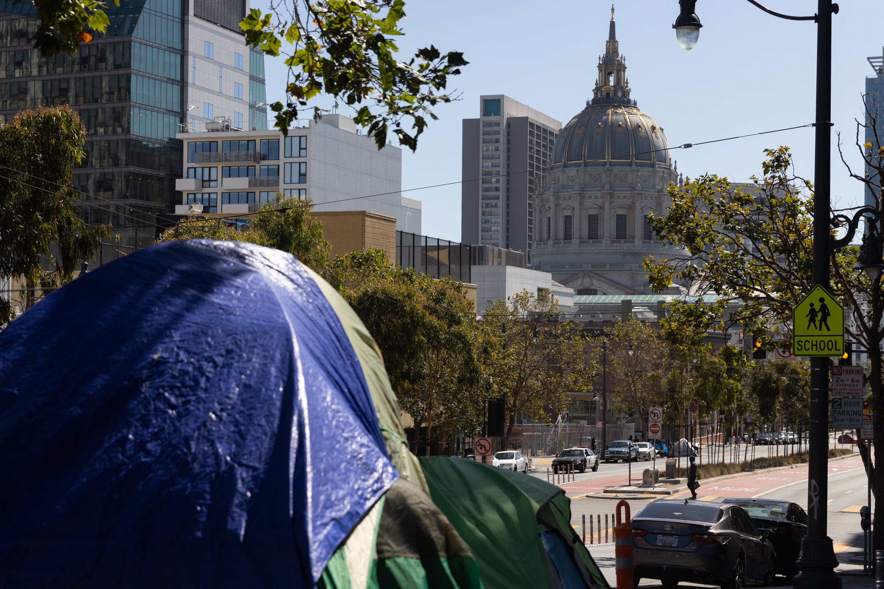 A tent with city hall in the background.