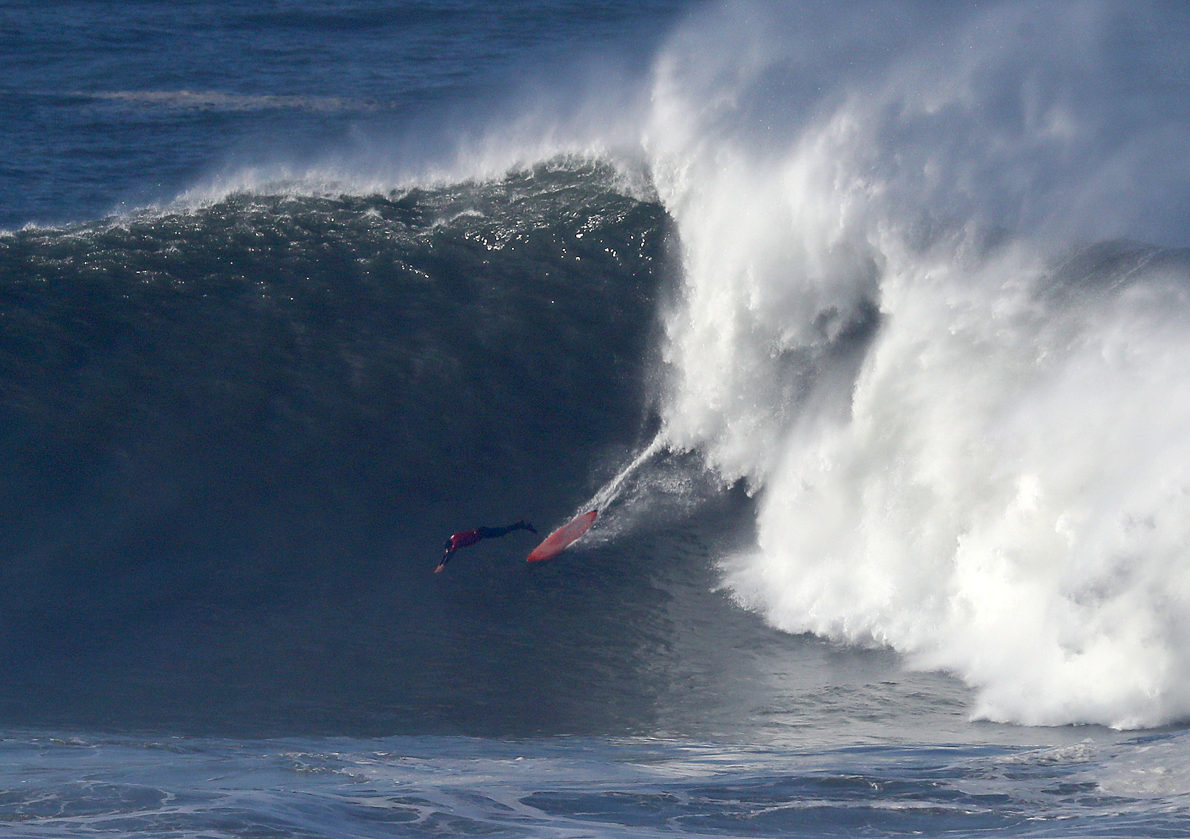 surfer rides big wave